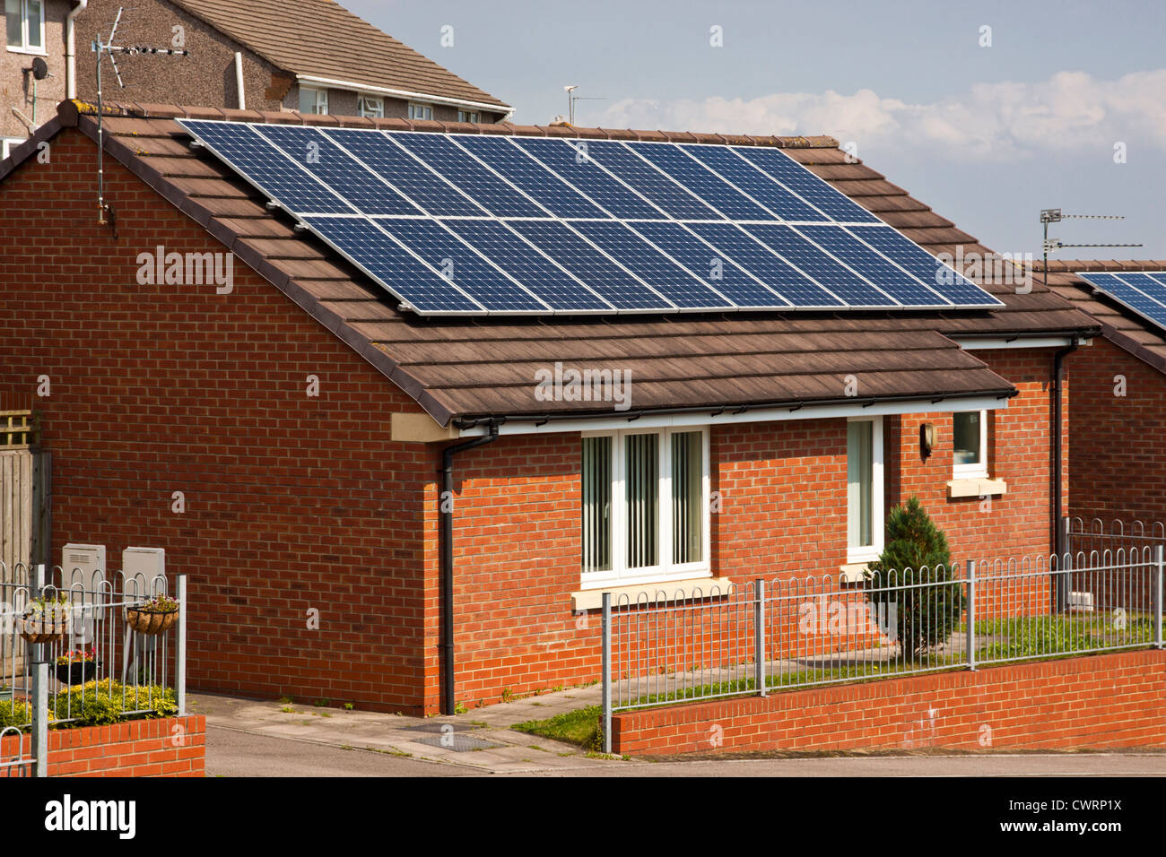 Solar pv photovoltaic panels on bungalows, creating free electricity. Stock Photo