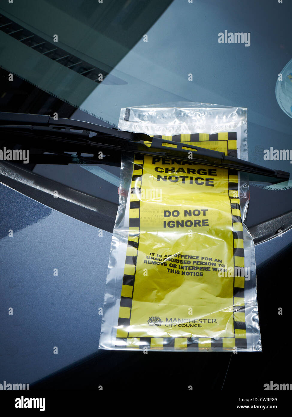 Parking ticket behind windscreen wiper as supplied by Manchester City Council UK Stock Photo