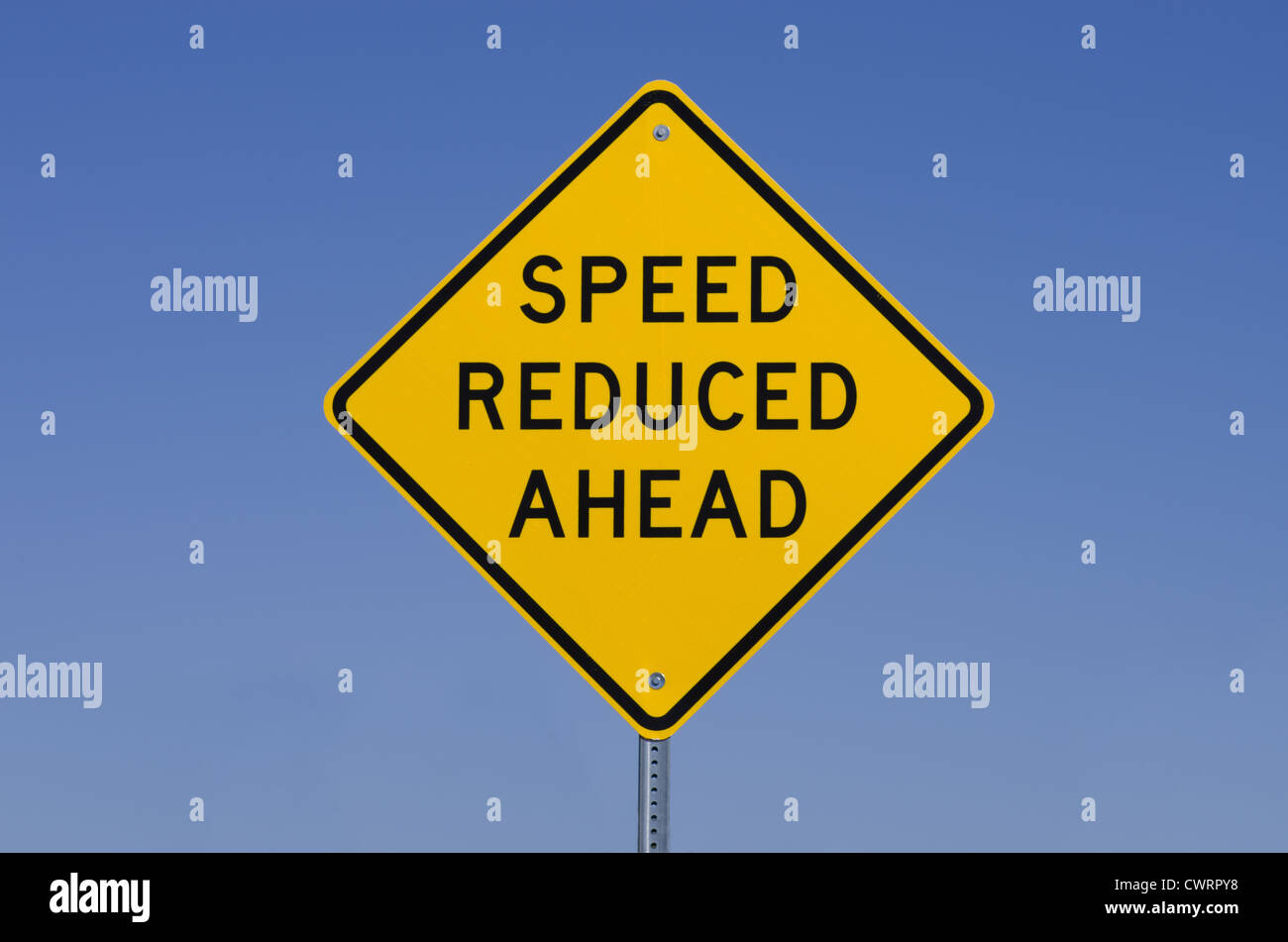 speed reduced ahead road sign with blue sky background Stock Photo