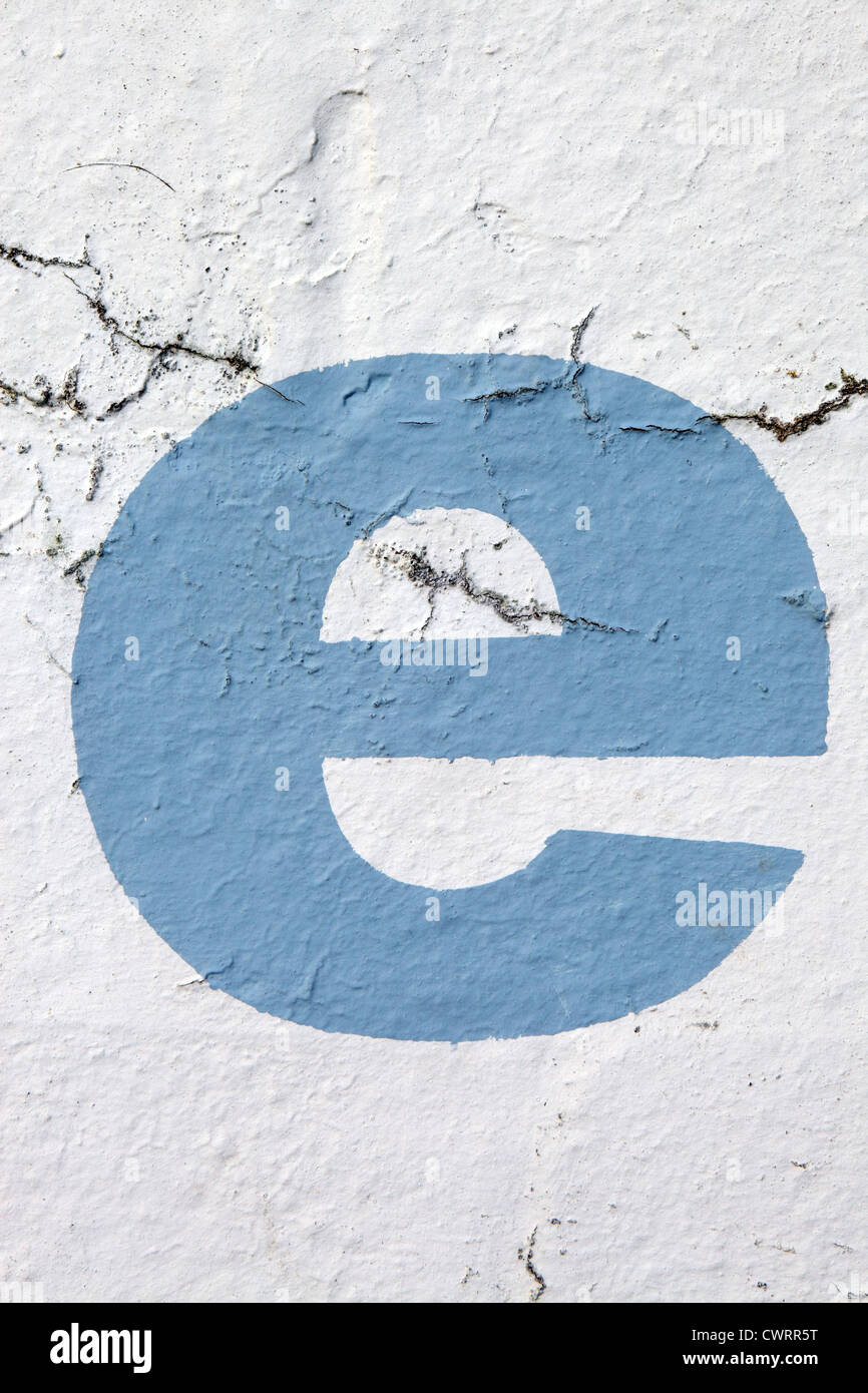 Lower case letter 'e' in sky blue paint stenciled onto crumbling exterior wall, UK. For other letters see Nick Sinclair folio Stock Photo