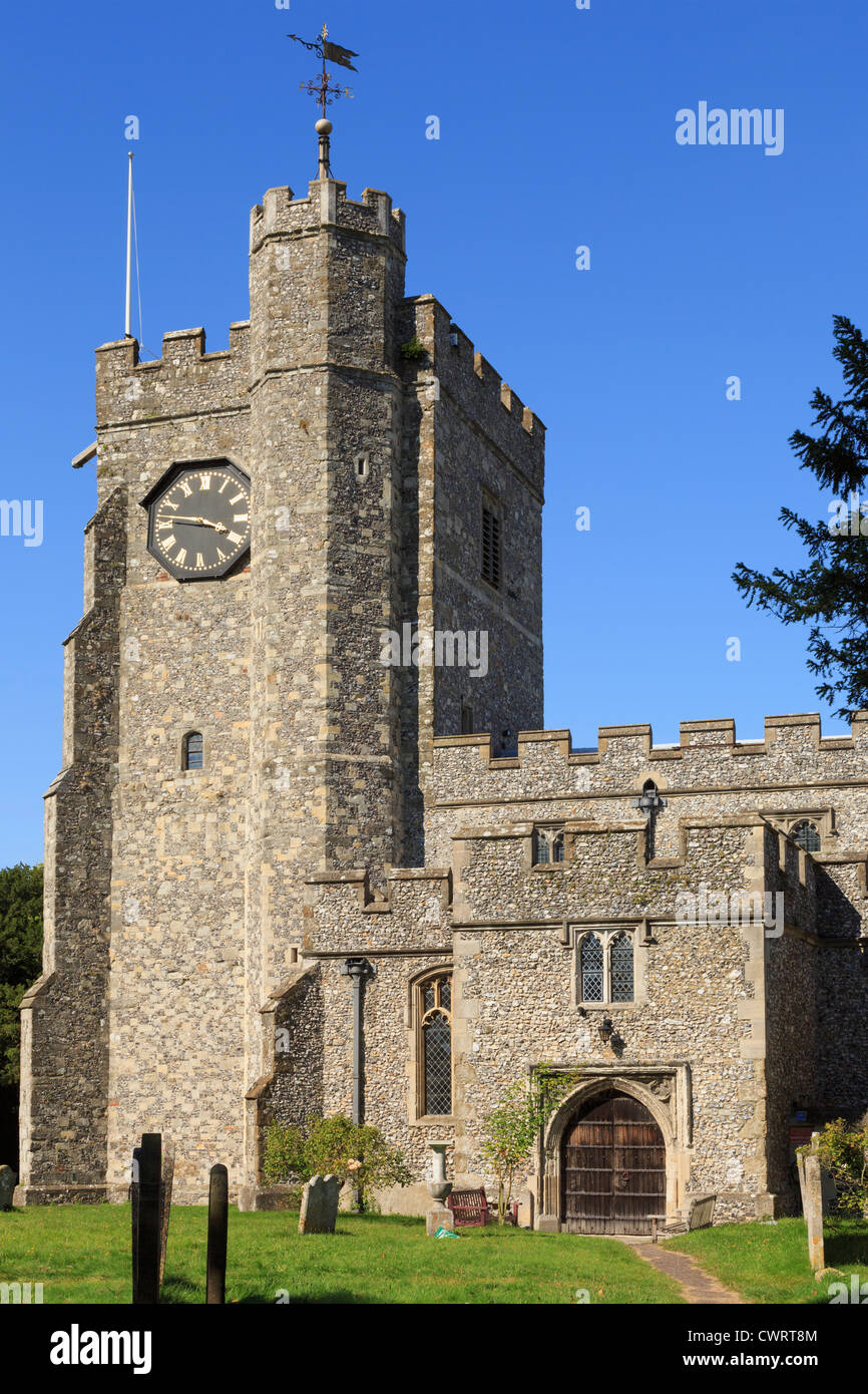 13th century St Mary's parish church clock tower and doorway from the churchyard in village on the Pilgrims Way. Chilham, Kent, England, UK, Britain Stock Photo