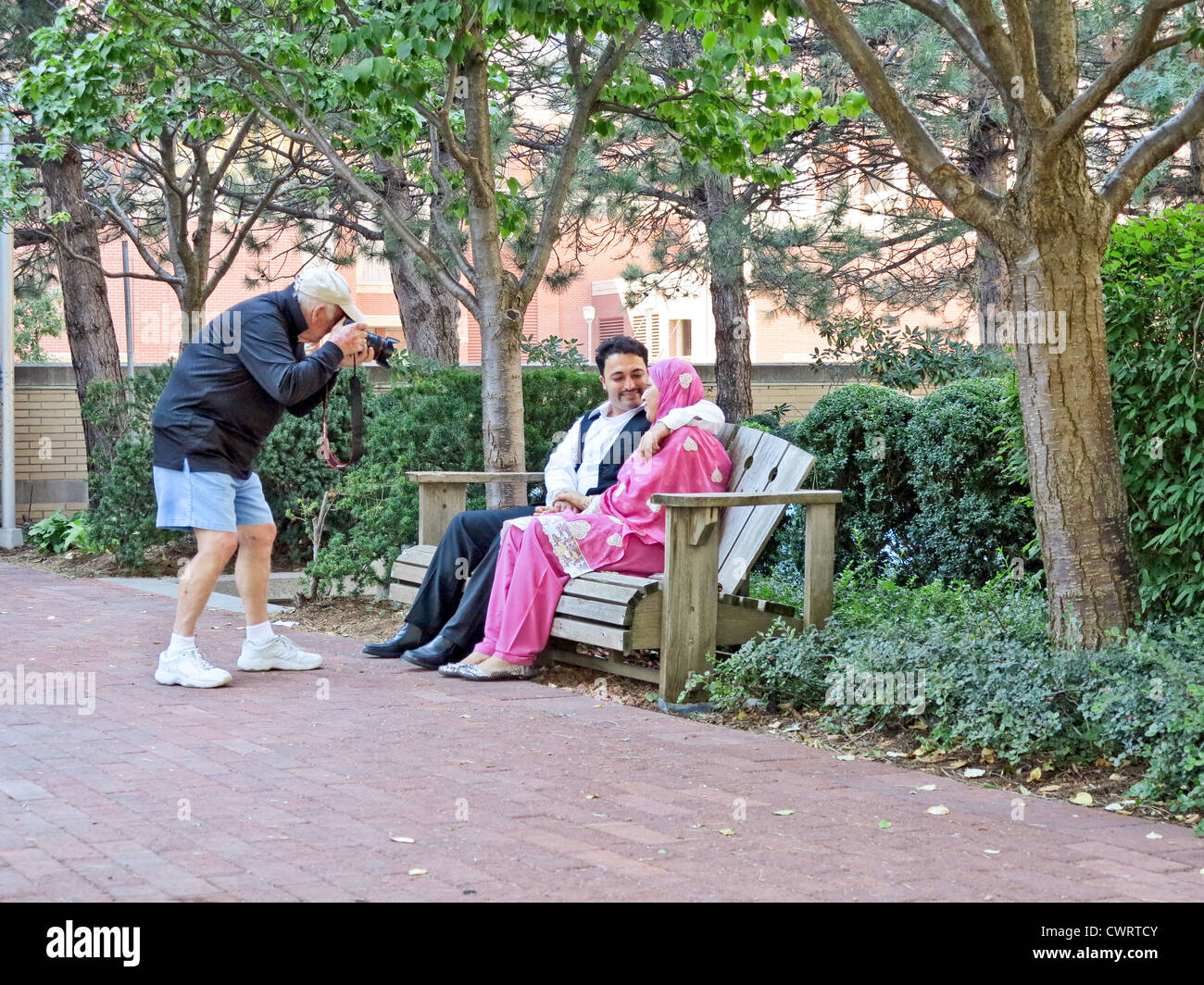 Photographer is photographing a young couple at Muslim Fest in Mississauga near Toronto;Ontario;Canada Stock Photo