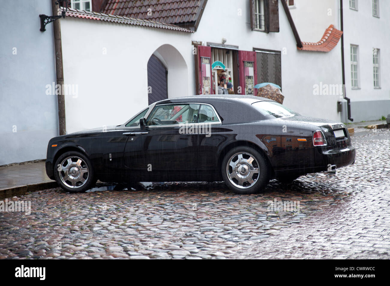 Rolls Royce Phantom parking in the streets; after the rain - car body is  covered with rain drops Stock Photo - Alamy