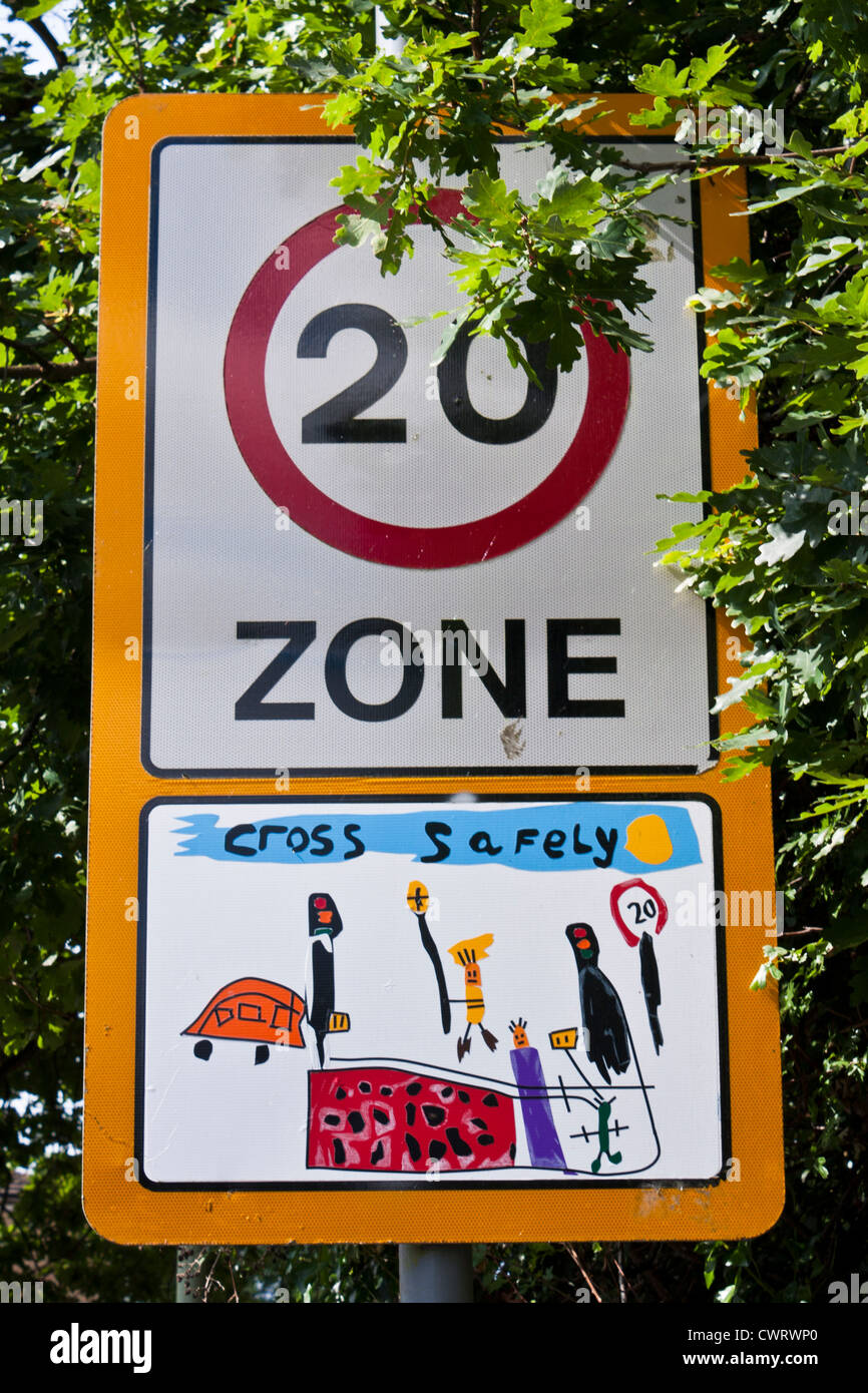 Traffic calming measures in the UK often include the use of children's drawings on speed limit signs in built-up areas. Stock Photo