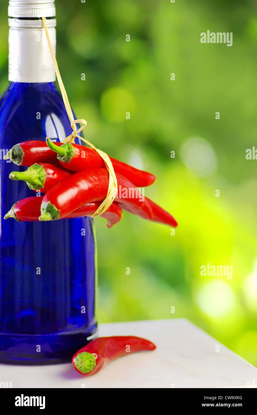bottle of alcohol and red chili peppers Stock Photo Alamy