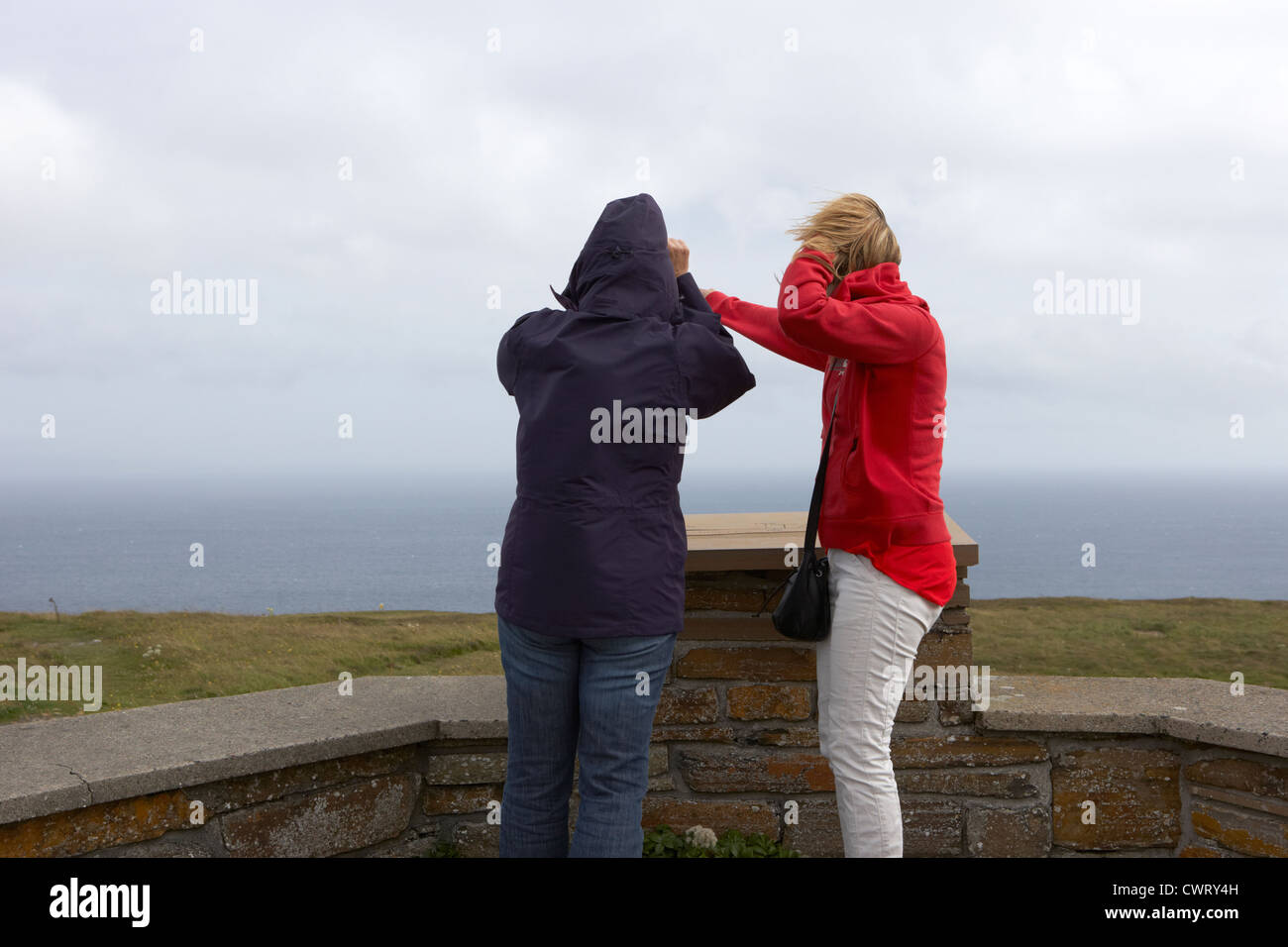 two female tourists at windy observation point on dunnet head most northerly point of mainland britain scotland uk Stock Photo