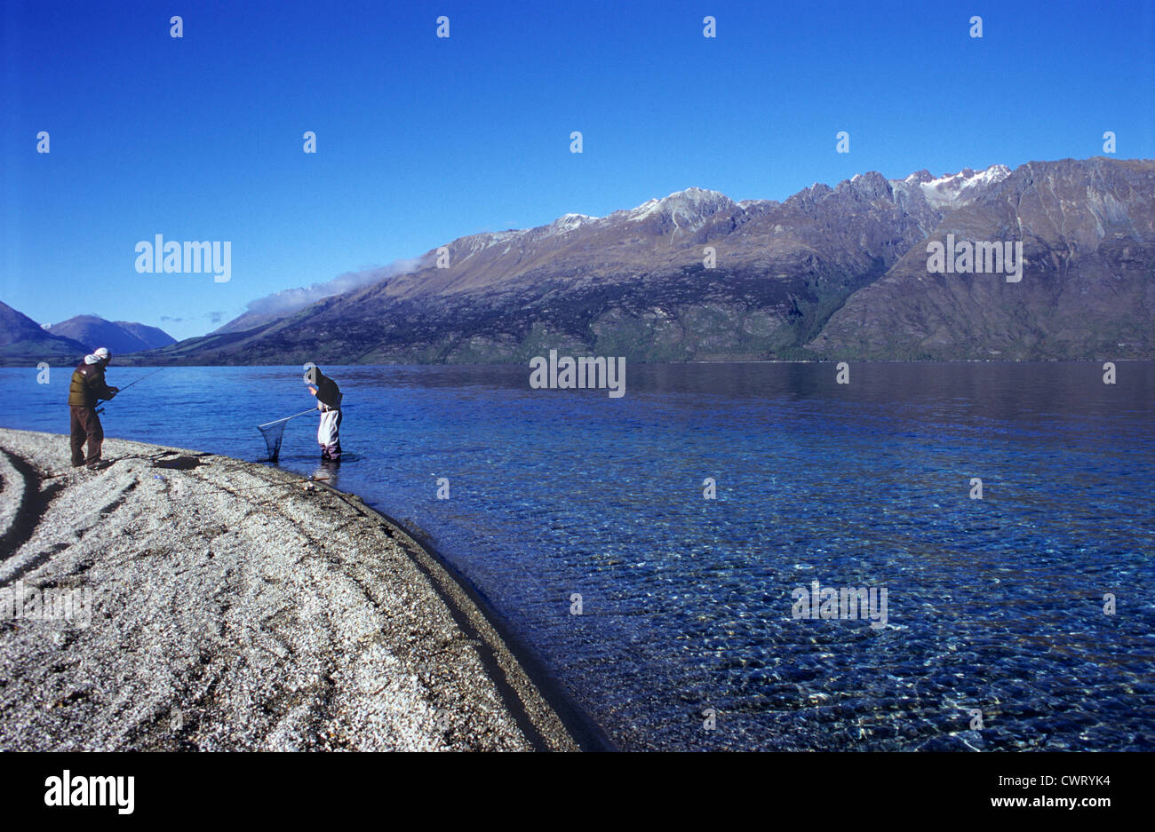 People fishing in Lake Wakatipu, South Island, New Zealand Stock Photo ...