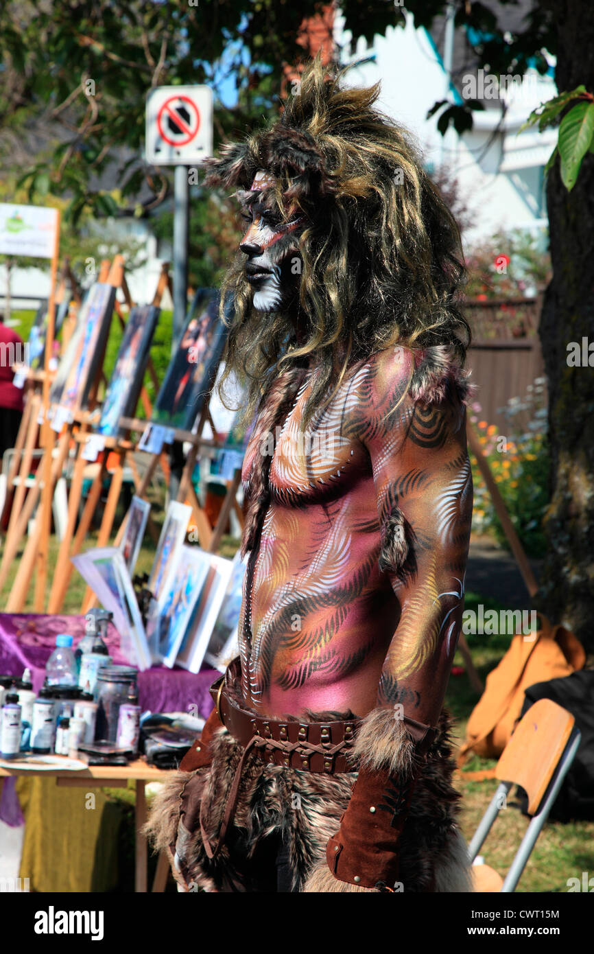 male model covered in body paint at a street art market Stock Photo