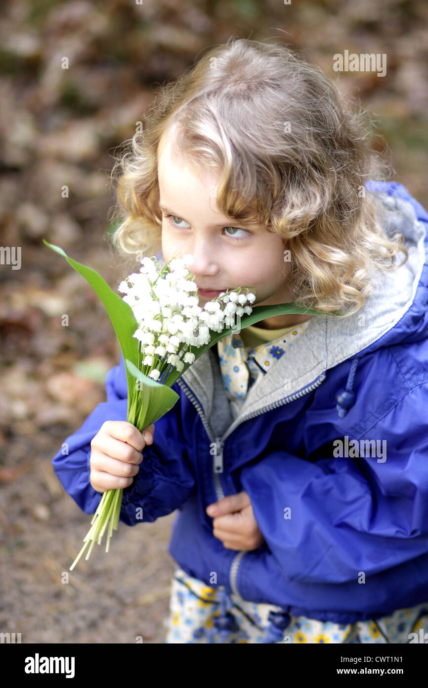 Lovely girl with a bouquet of lily of the valley Stock Photo - Alamy