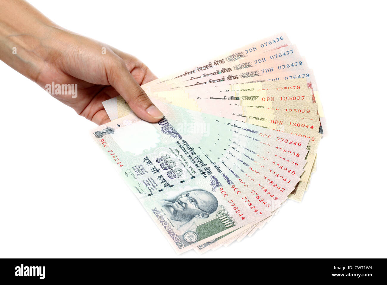 Hand holding Indian rupee notes on white background Stock Photo