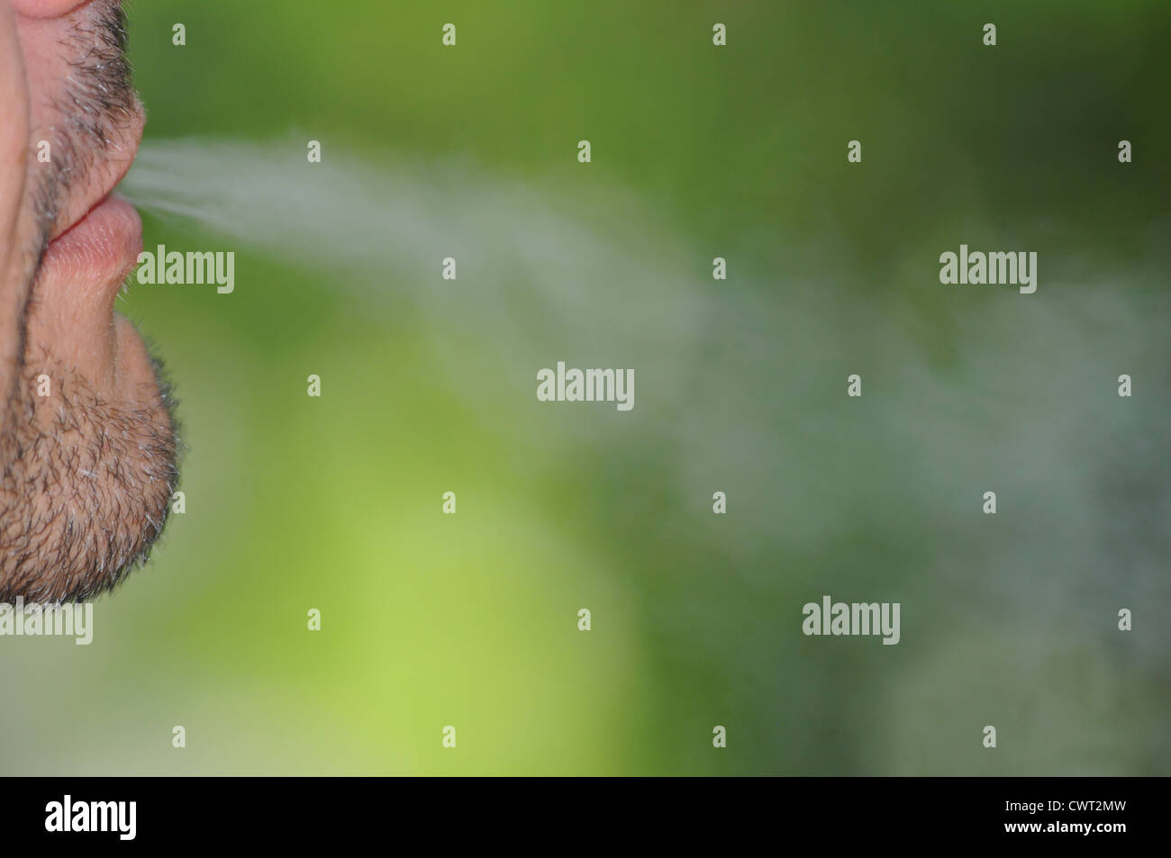 Smoker exhaling cigarette smoke. Stock Photo