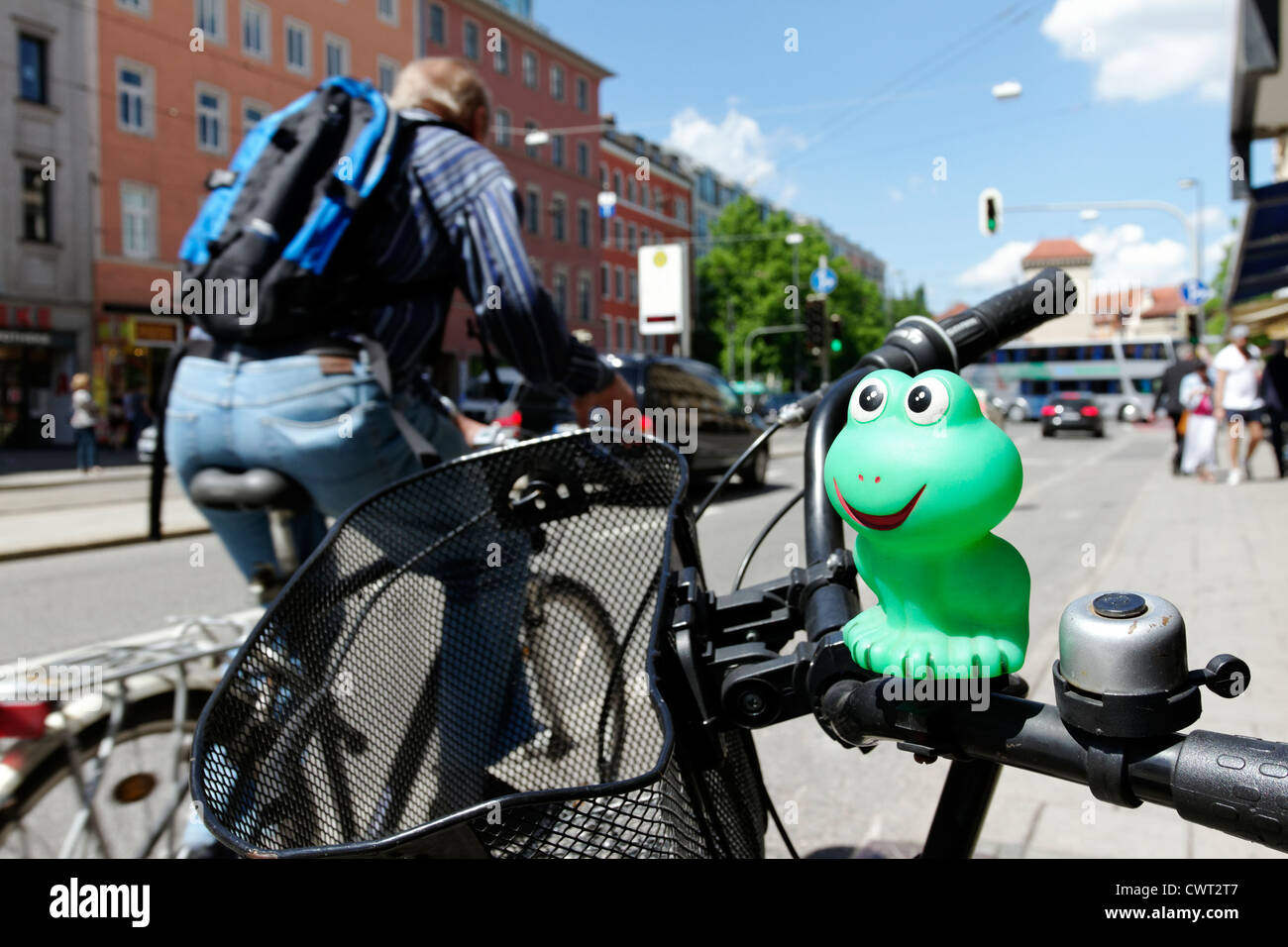 Green rubber mascot on bike handle bars, Munich Upper Bavaria Germany Stock Photo