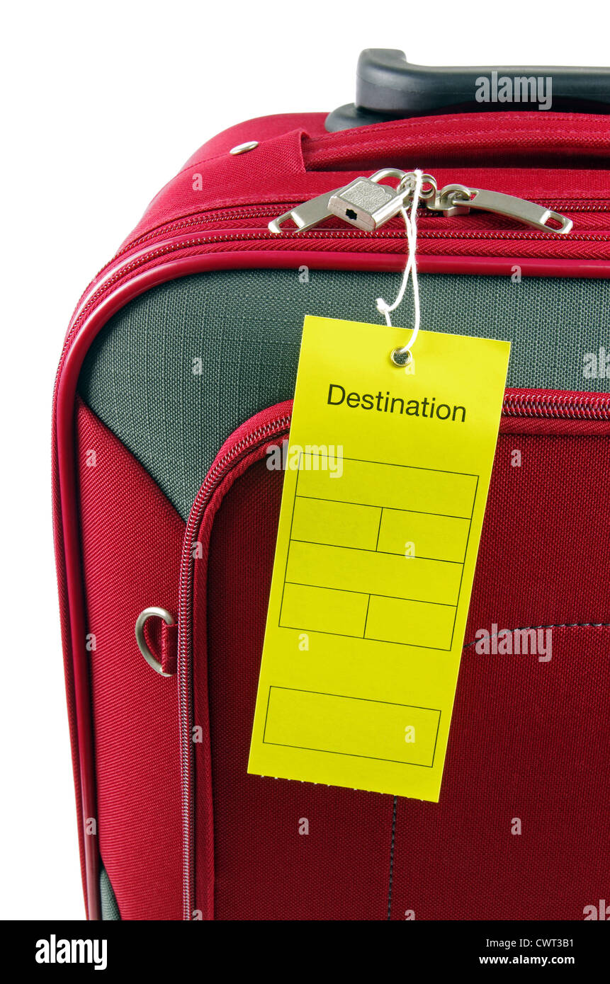 yellow destination label on a red travel bag Stock Photo