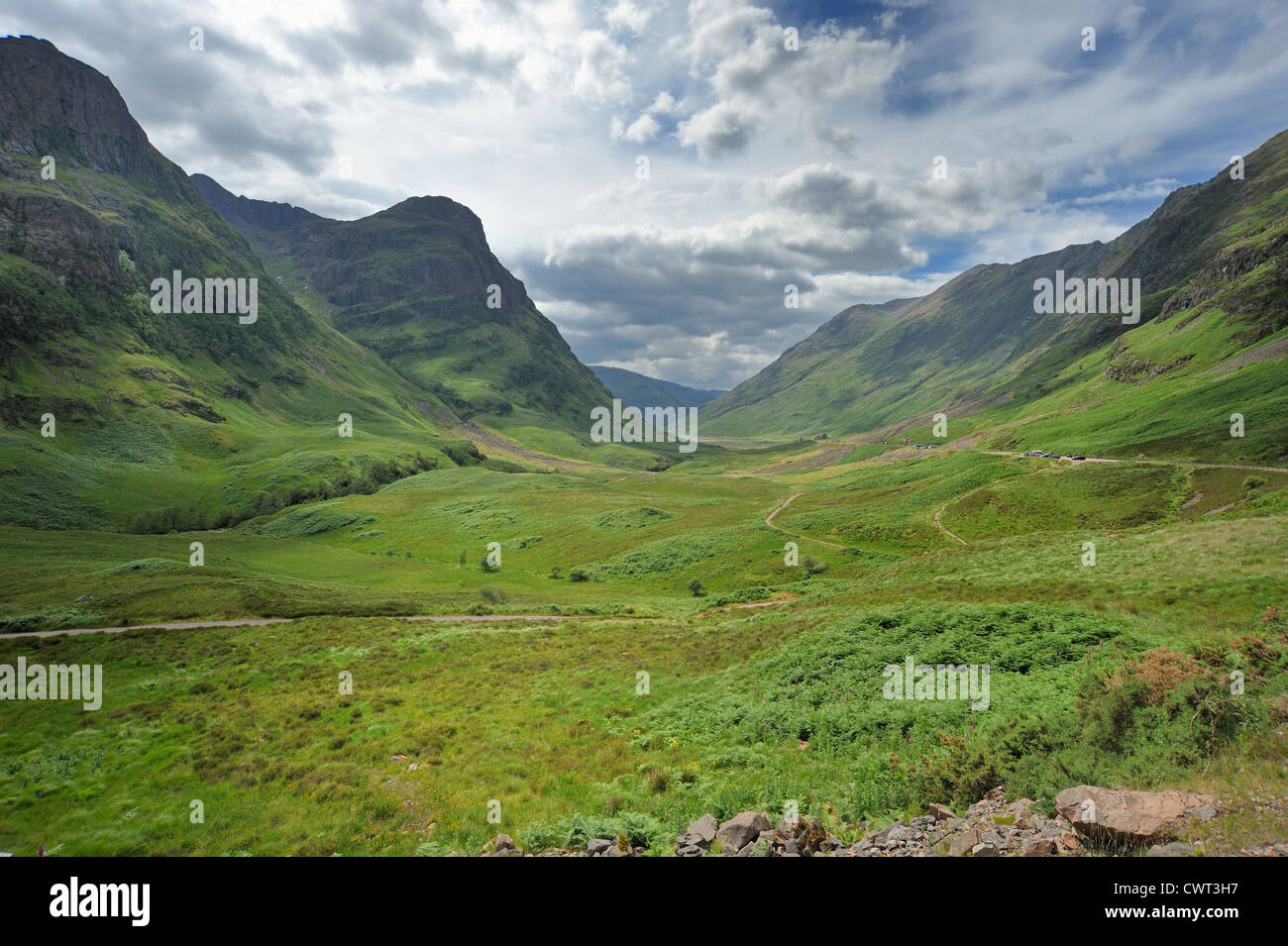 A road leads down through the mountains of the Glencoe valley Stock Photo