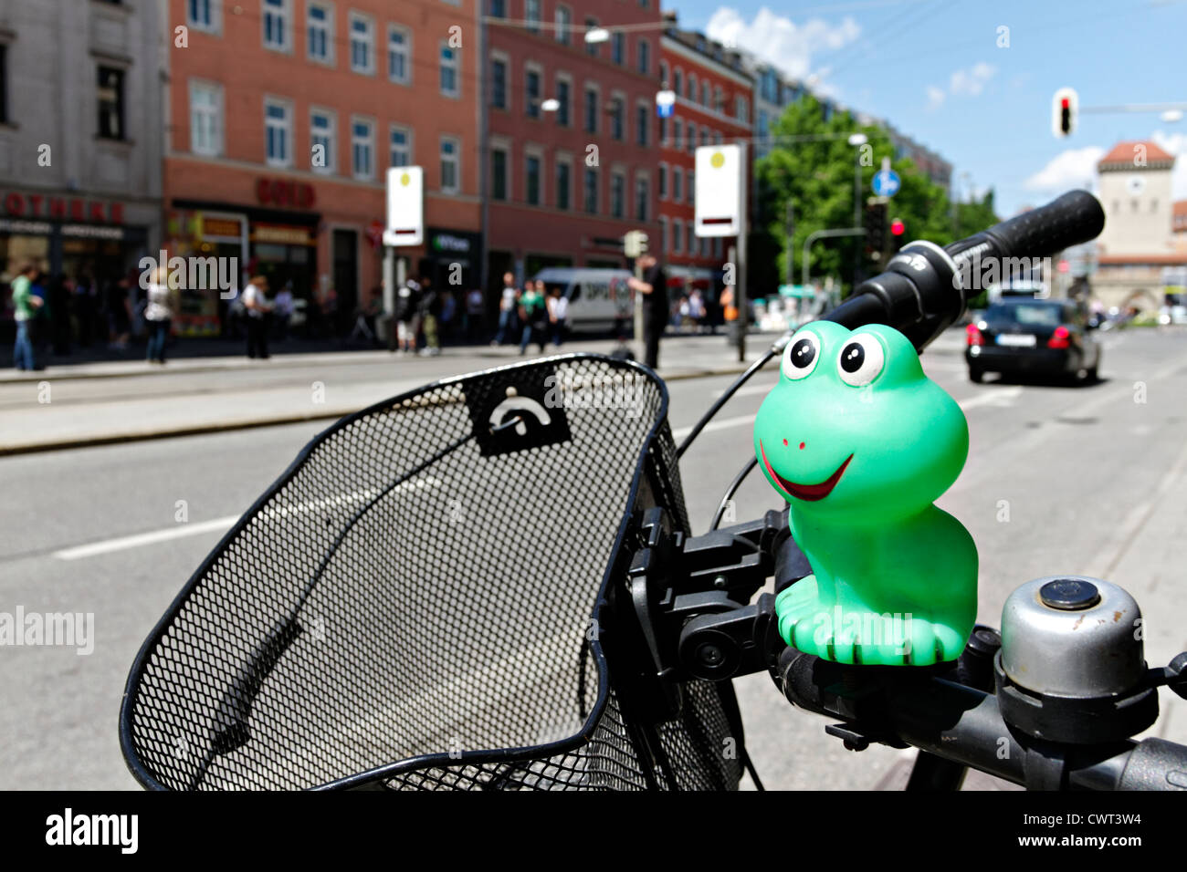 Green rubber mascot on bike handle bars, Munich Upper Bavaria Germany Stock Photo