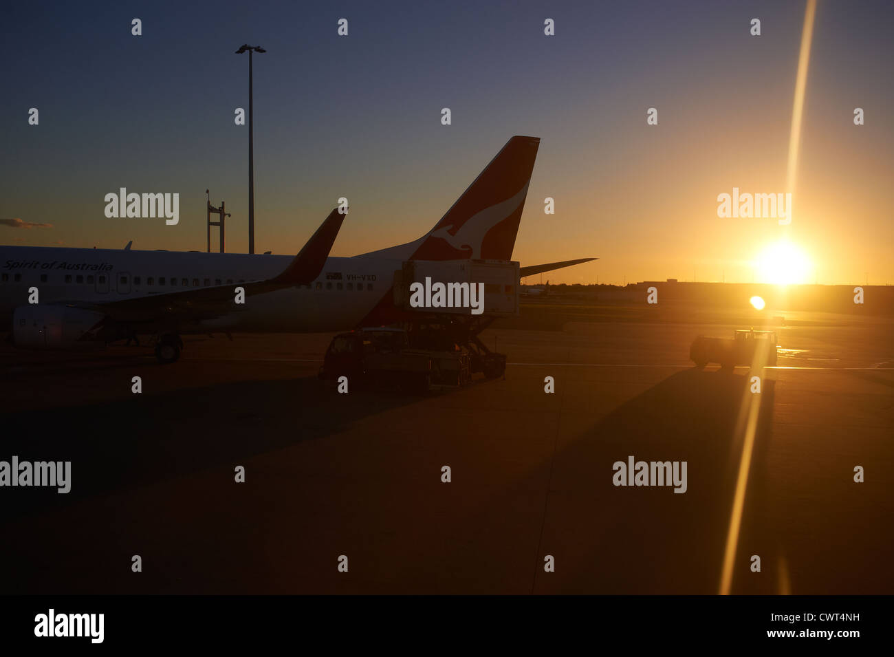 Qantas jets in silhouette on the tarmac at the Brisbane airport terminal Australia Stock Photo