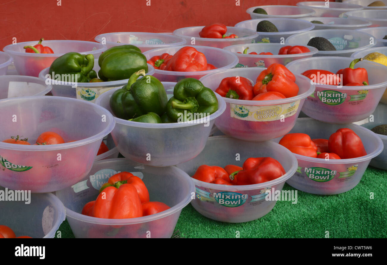 Red and green peppers on table outside off-license Stock Photo