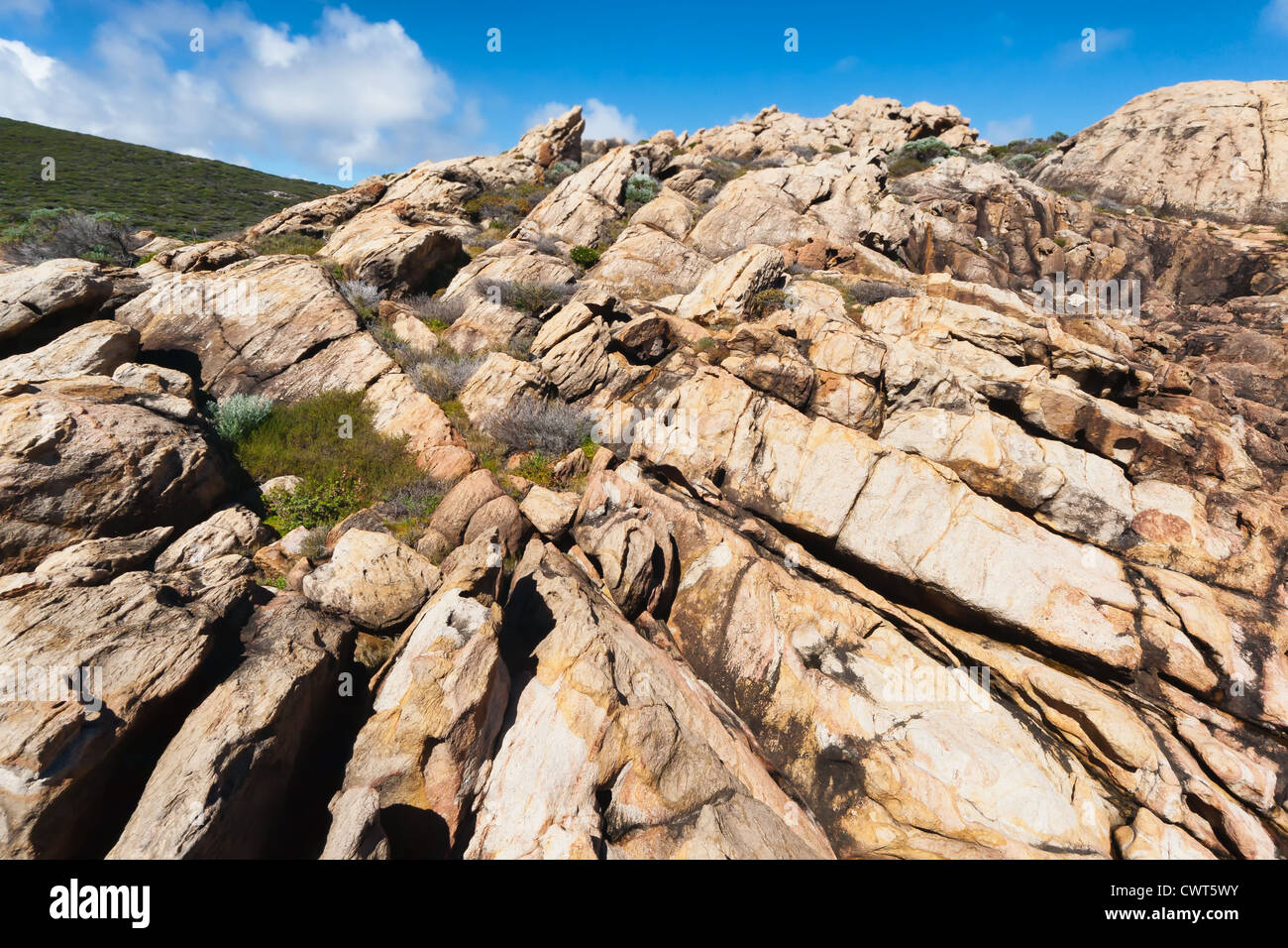 A series of rocks jut into the ocean creating a natural canal hollowed out by the force of the sea. Stock Photo