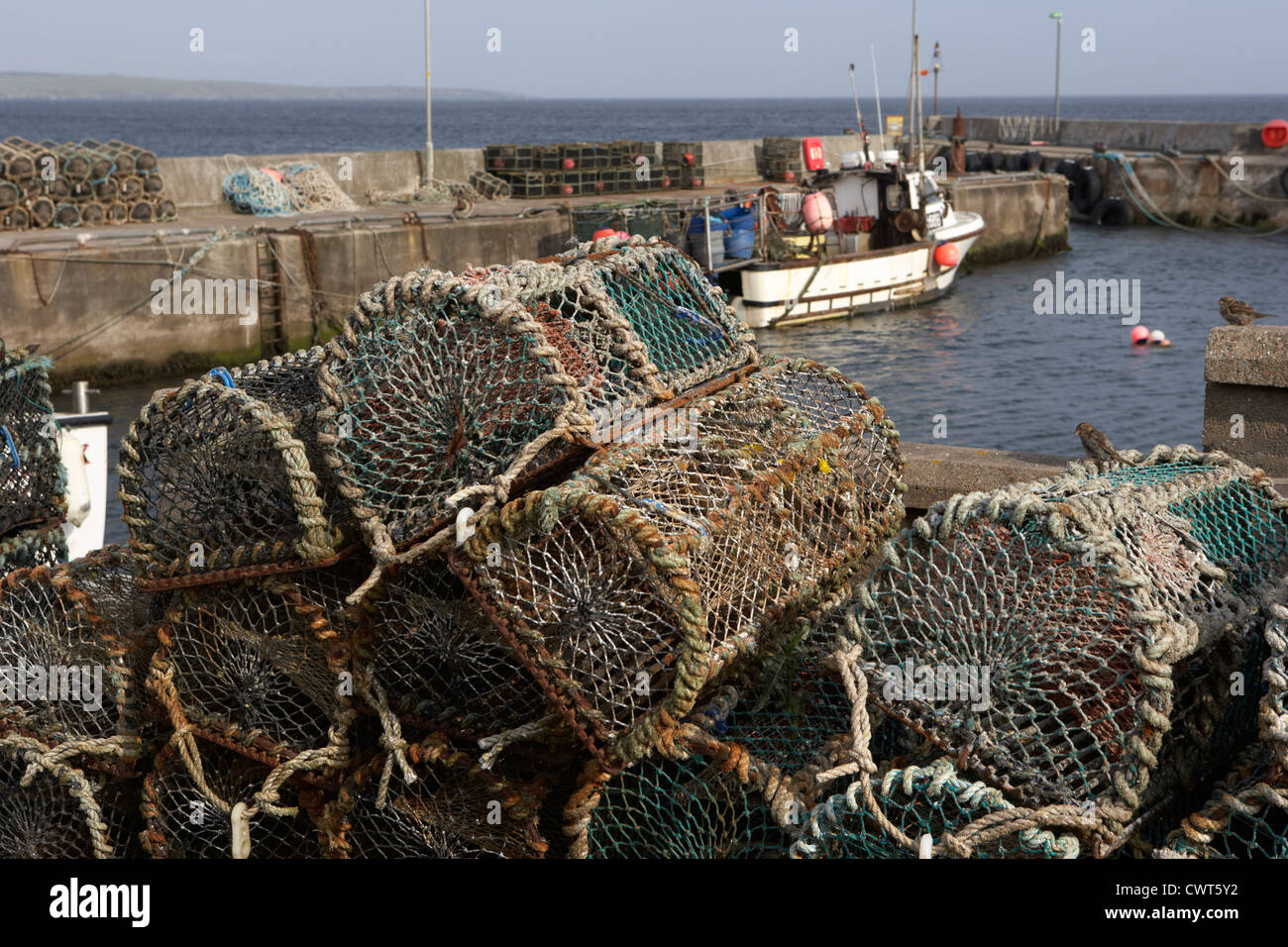 old lobster pots piled up at John O'Groats harbour scotland uk Stock Photo