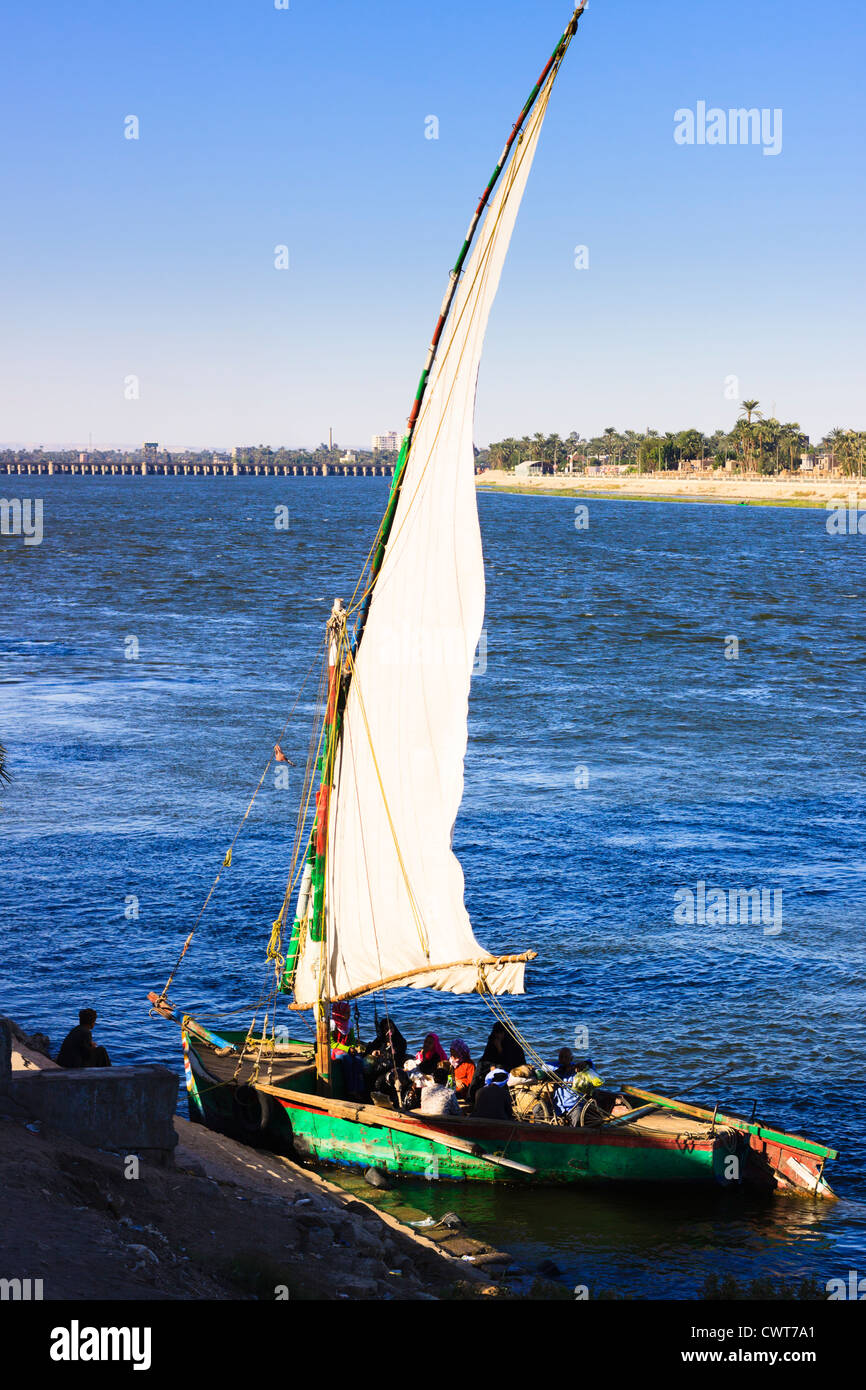 Public felucca ferrying locals from shore to shore over the Nile. Asyut Egypt Stock Photo