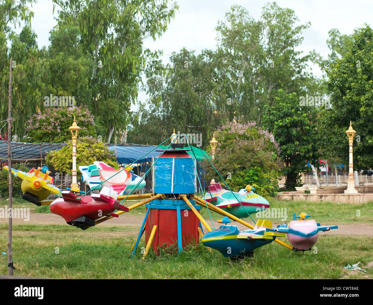 Old carousel with airplanes at playground in Sisophon, Cambodia. Stock Photo