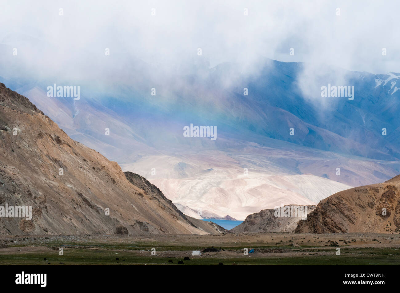 Seen from a nomad camp, a rainbow hovers over the high-altitude lake Tso Moriri (4520 metres) in Ladakh, India's Little Tibet Stock Photo