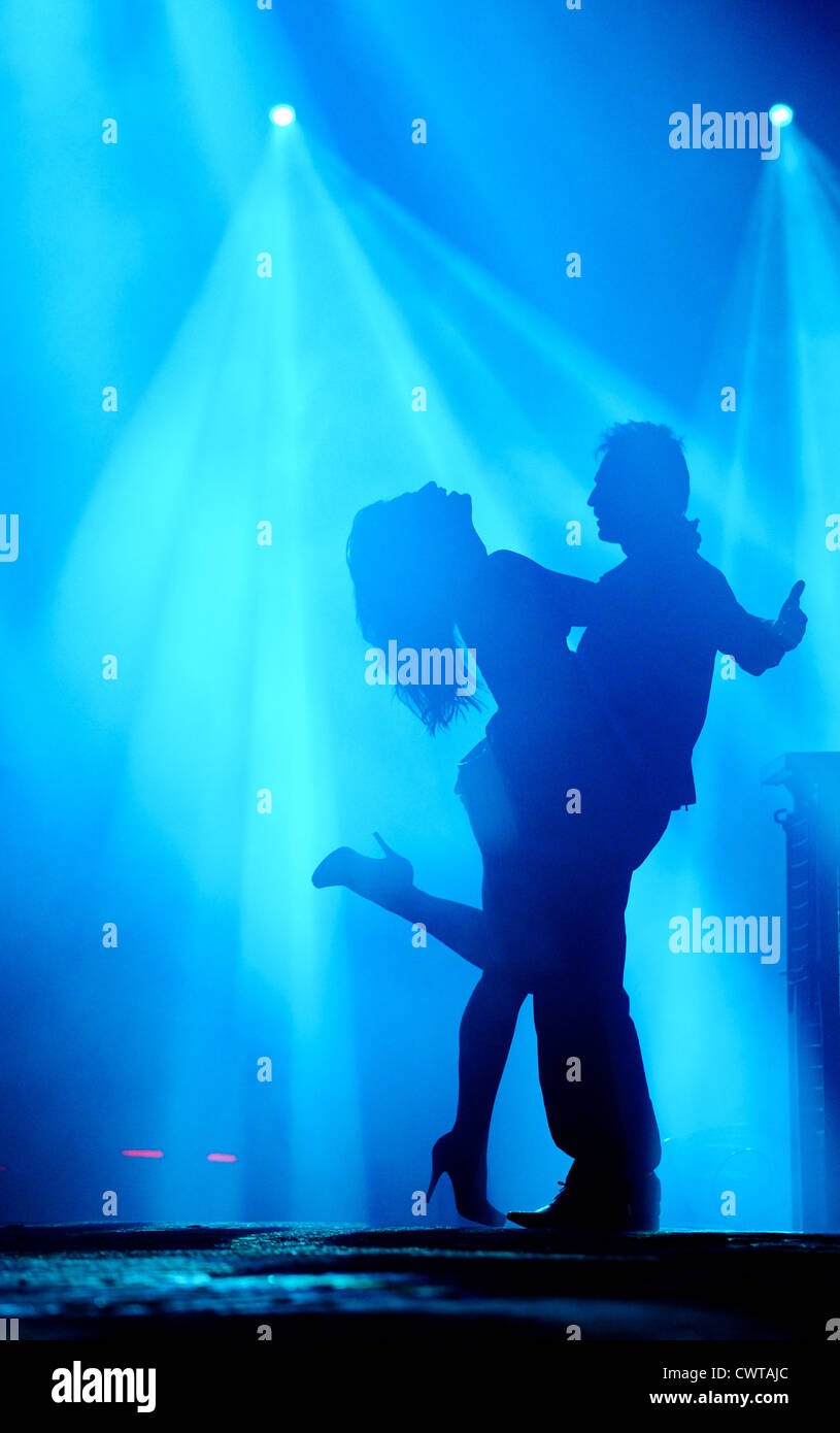 Couple dancing in spotlight Stock Photo