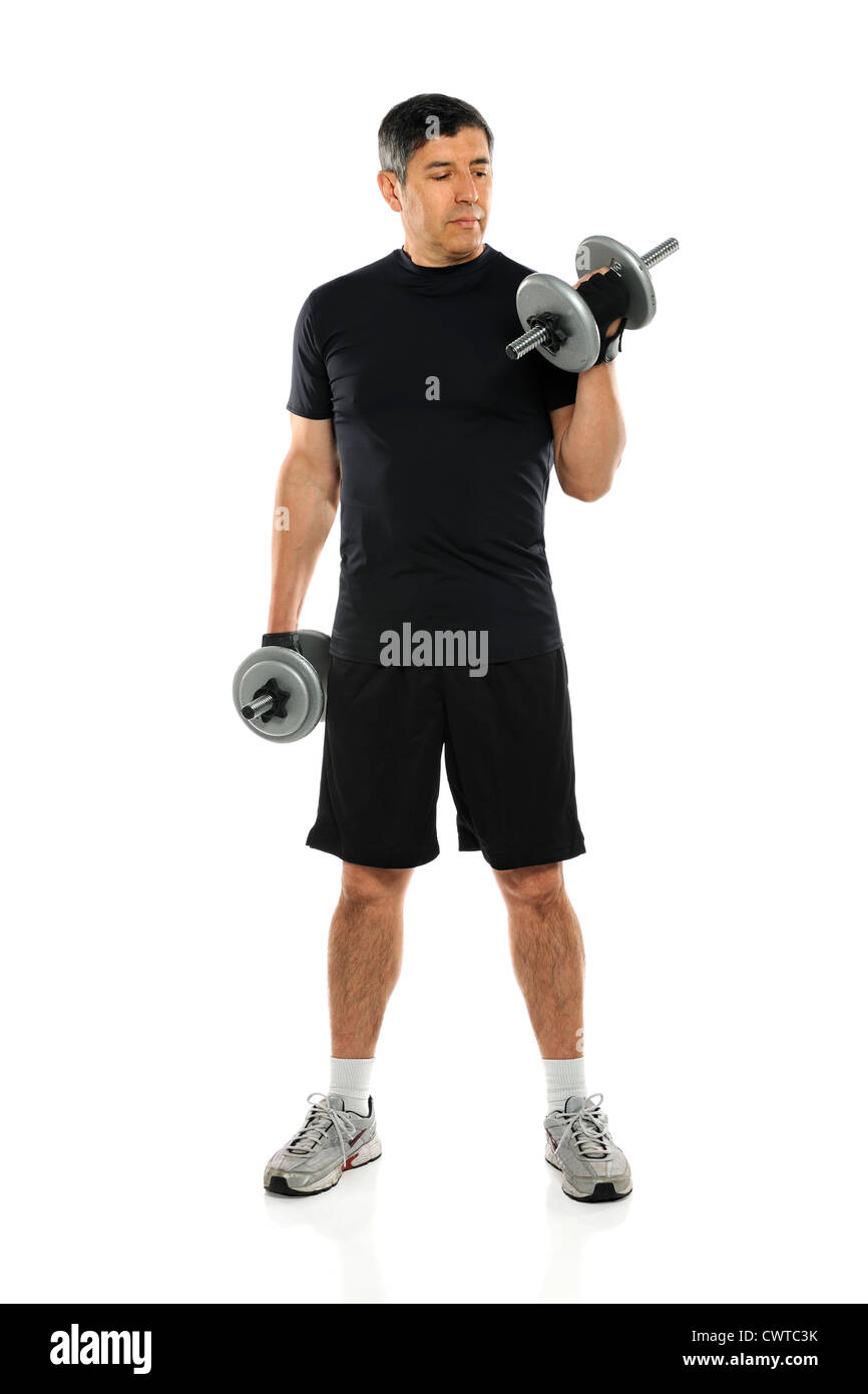 Hispanic mature man exercising with dumbbells isolated over white background Stock Photo