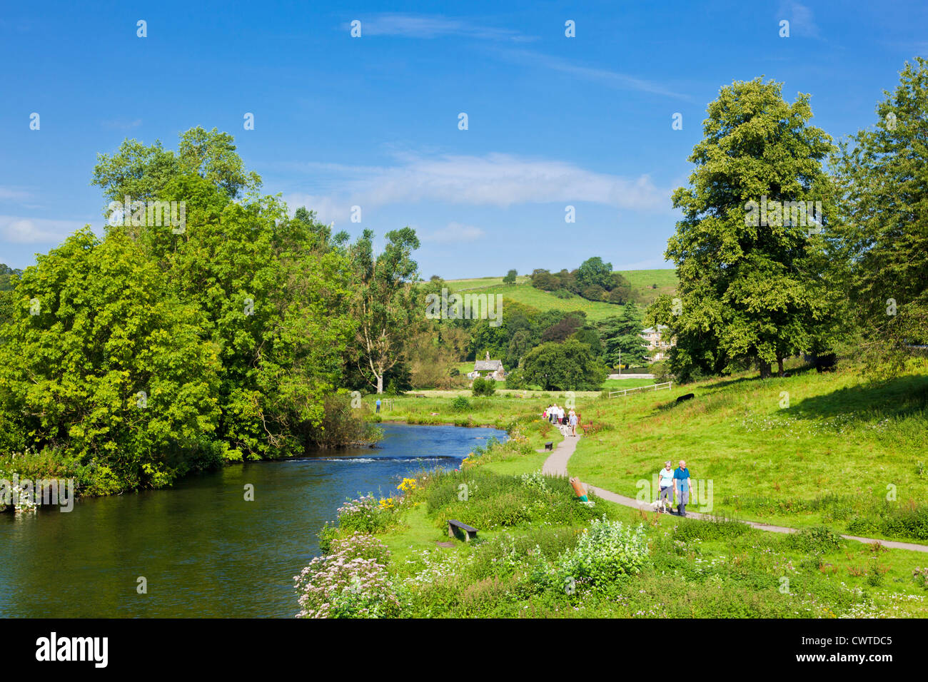 People walking along the River Wye at Bakewell Derbyshire Peak District National Park England UK GB EU Europe Stock Photo