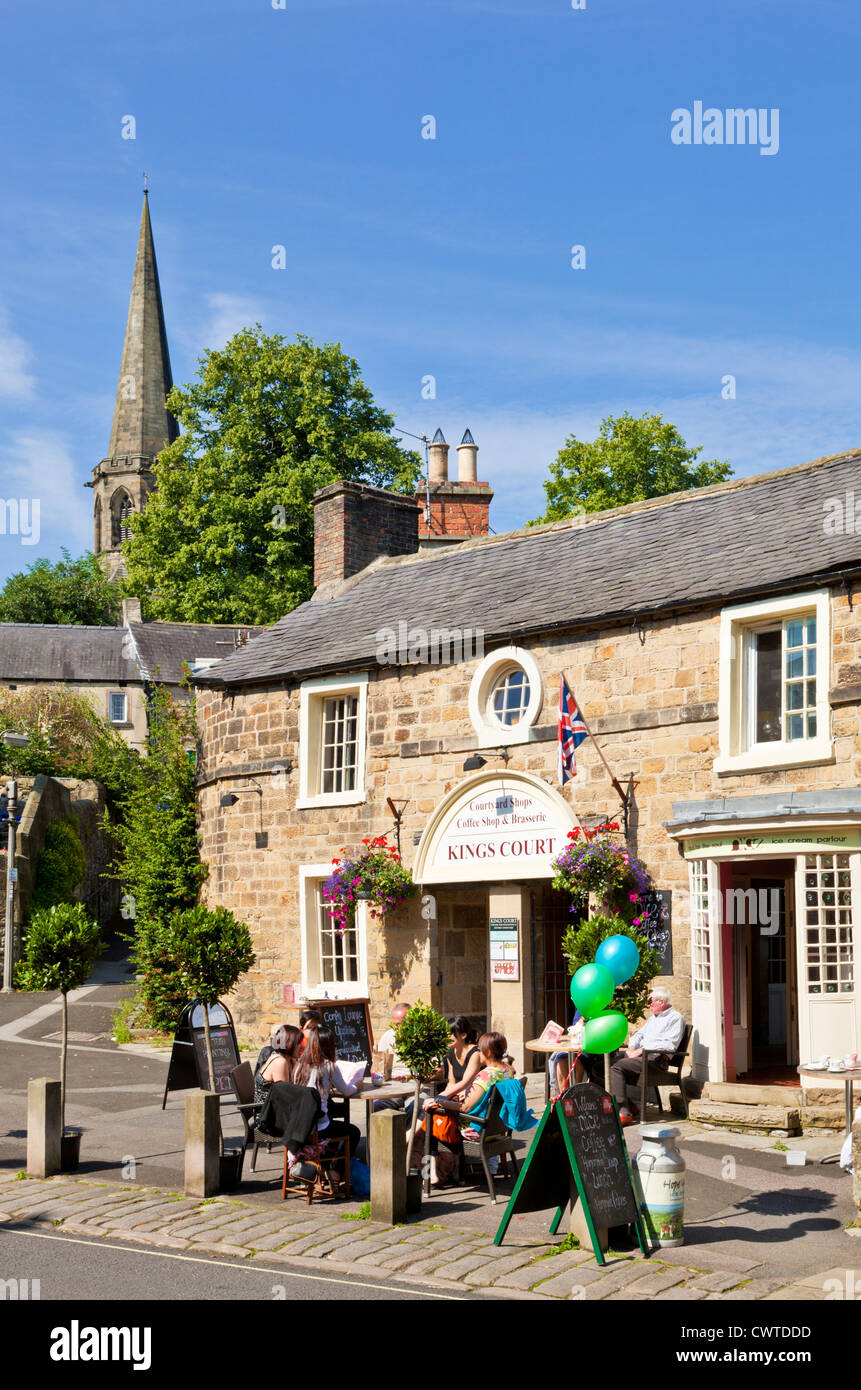 People eating and drinking at Kings Court cafe and shops Bakewell Derbyshire Peak District England UK GB EU Europe Stock Photo