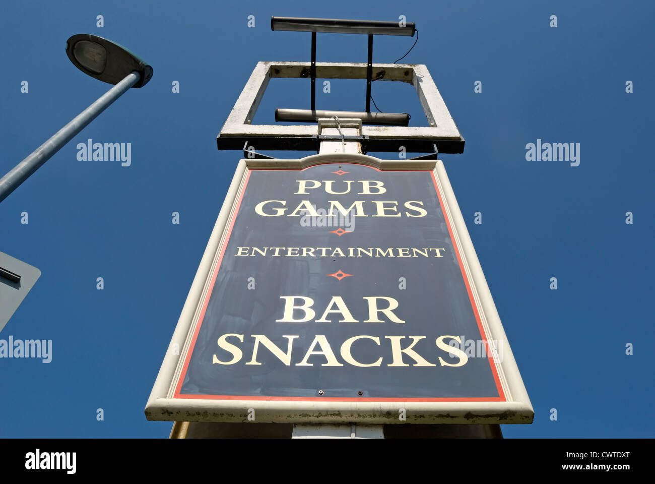 empty pub sign frame outside a closed pub with board below advertising pub games and bar snacks, hounslow, middlesex, england Stock Photo