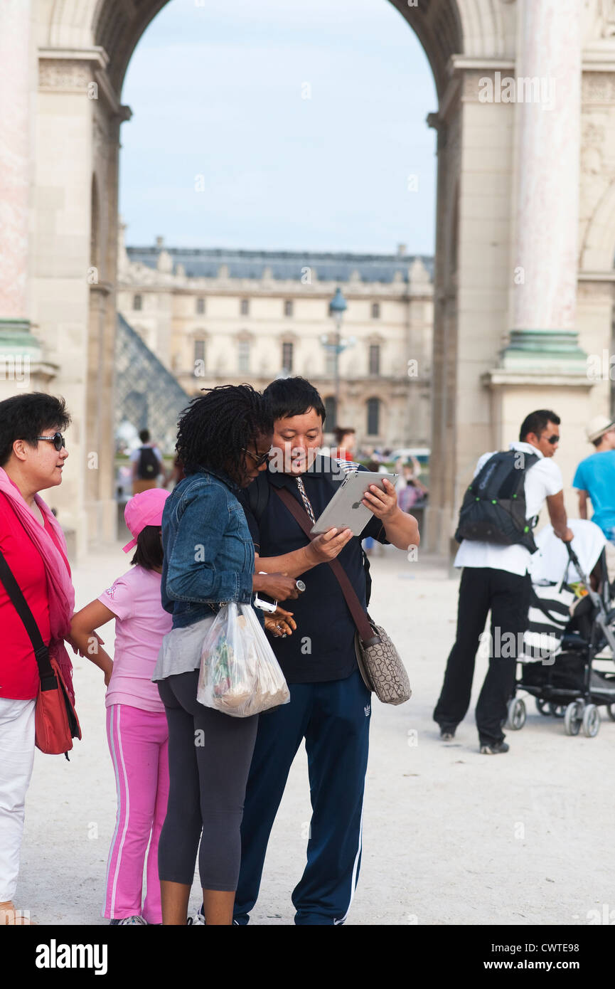 Paris France - Couple tourists using digital tablet Stock Photo