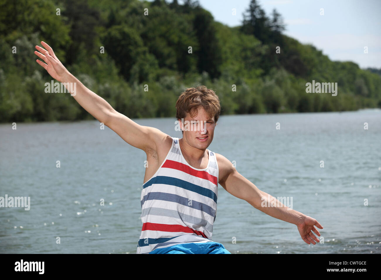 Young man in summer wear at River Isar, Munich, Bavaria, Germany Stock Photo