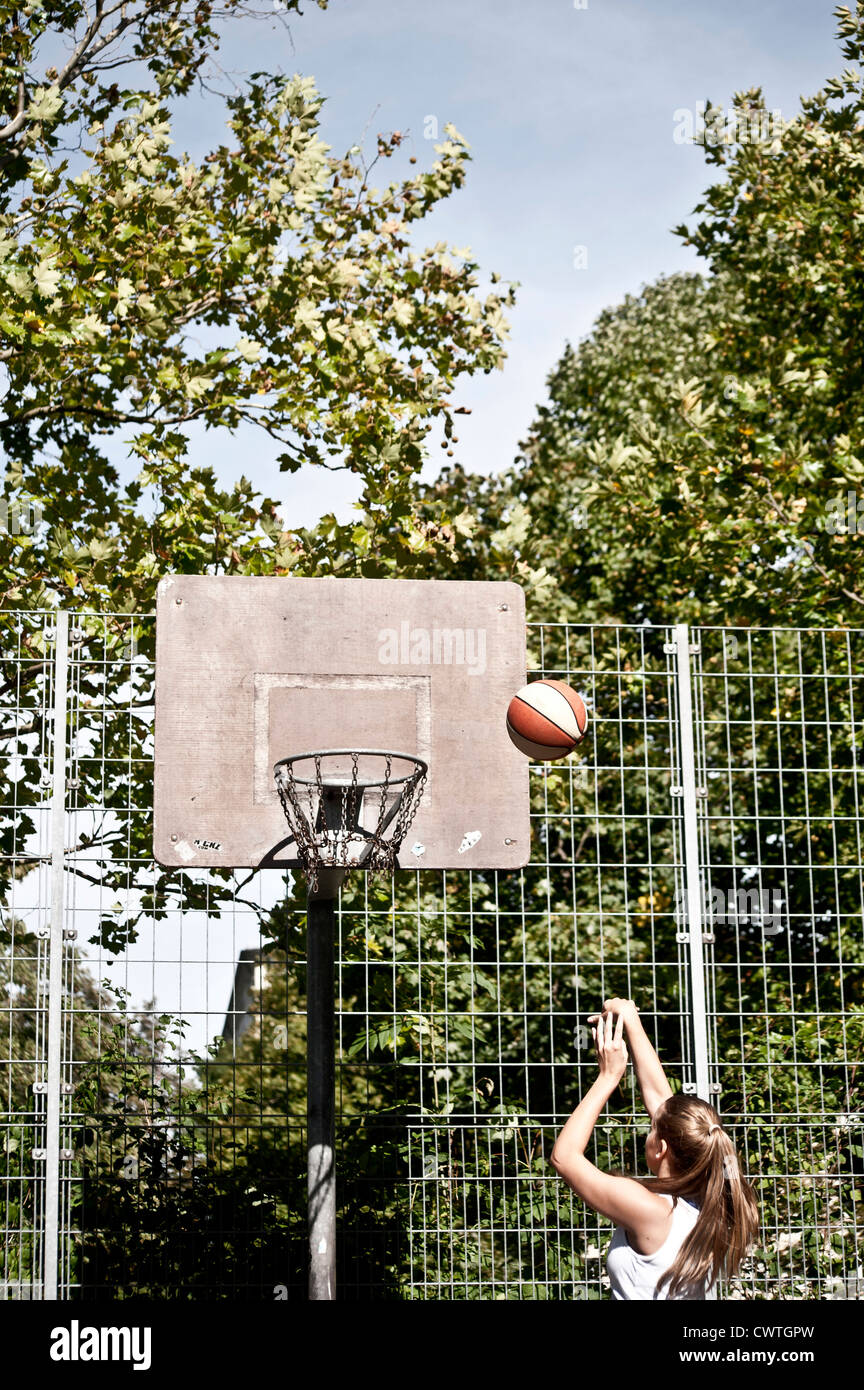 Teenage girl throwing basketball Stock Photo Alamy