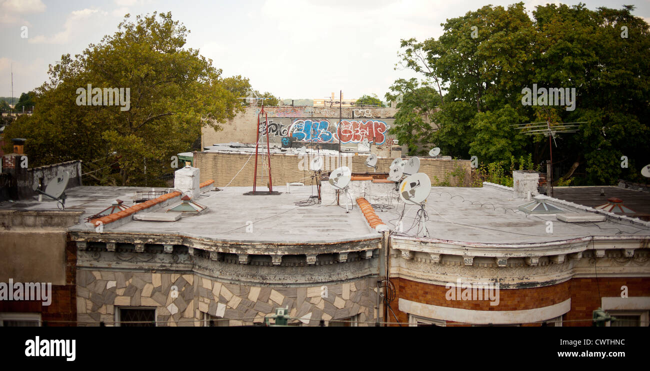 Satellite dishes atop homes in the East New York neighborhood of Brooklyn in New York Stock Photo