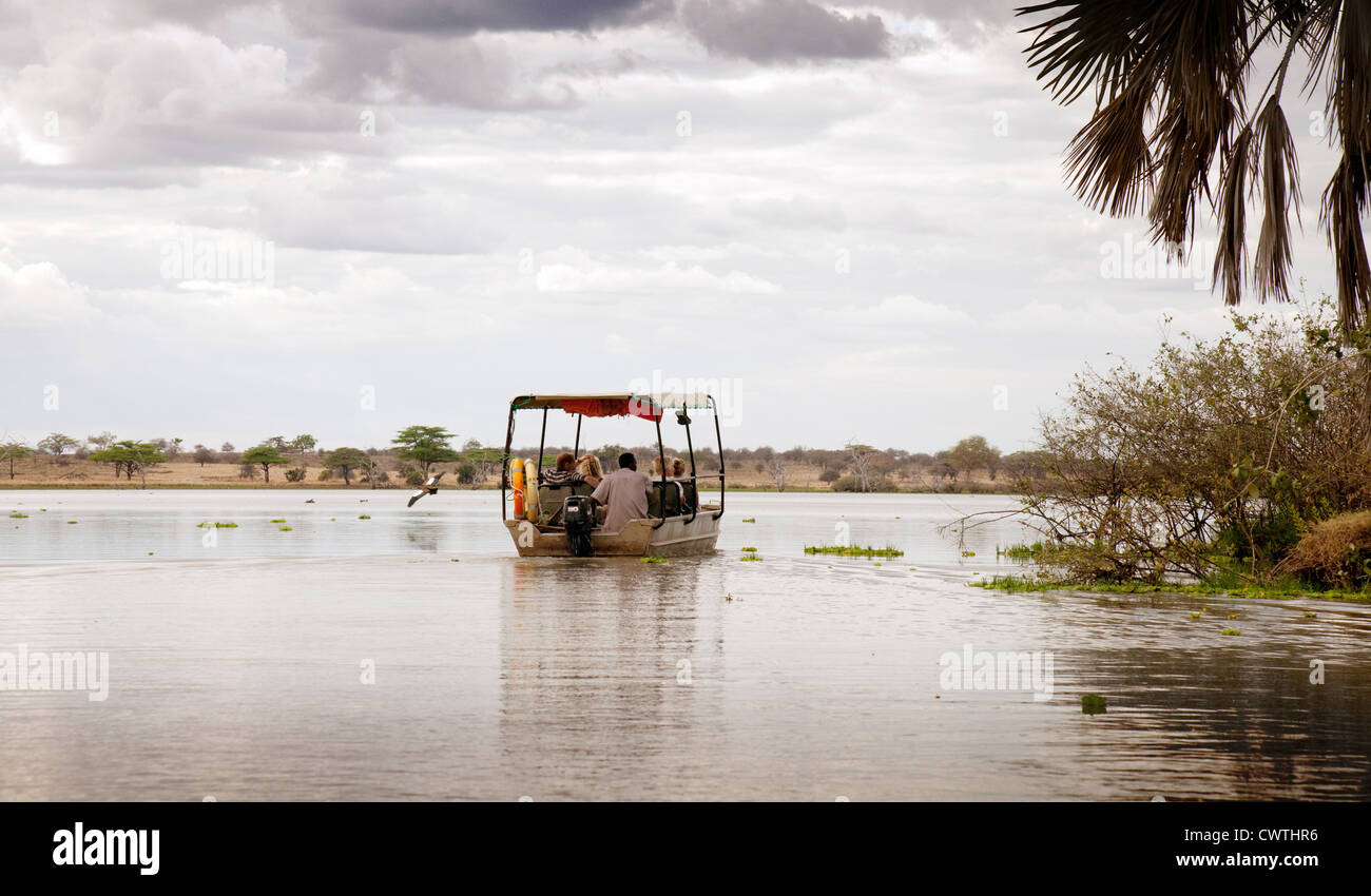 Tourists on a boat safari, Lake Manze, Selous Game Reserve Tanzania Africa Stock Photo