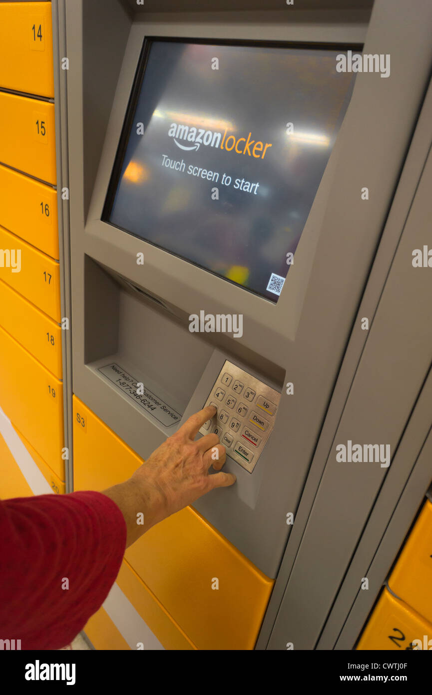 An Amazon customer picks up her package in an Amazon Locker in a