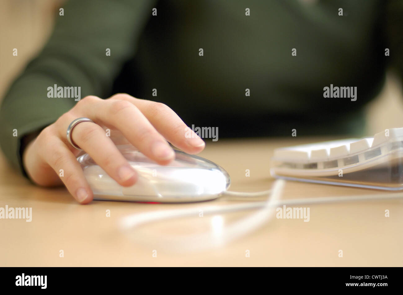 Woman's hand using computer mouse Stock Photo - Alamy
