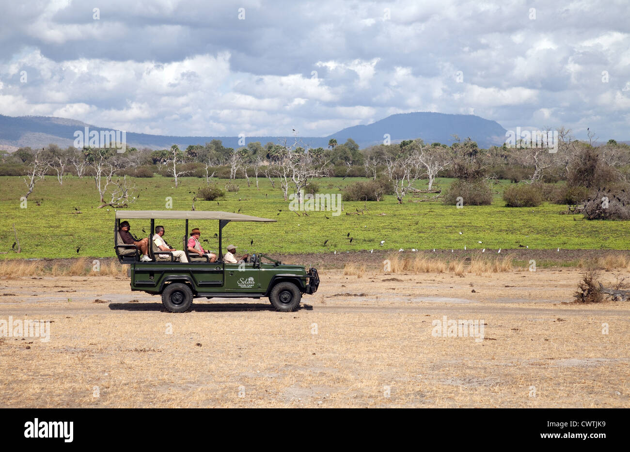 Tourists on a jeep safari holiday, the Selous Game reserve Tanzania Africa Stock Photo