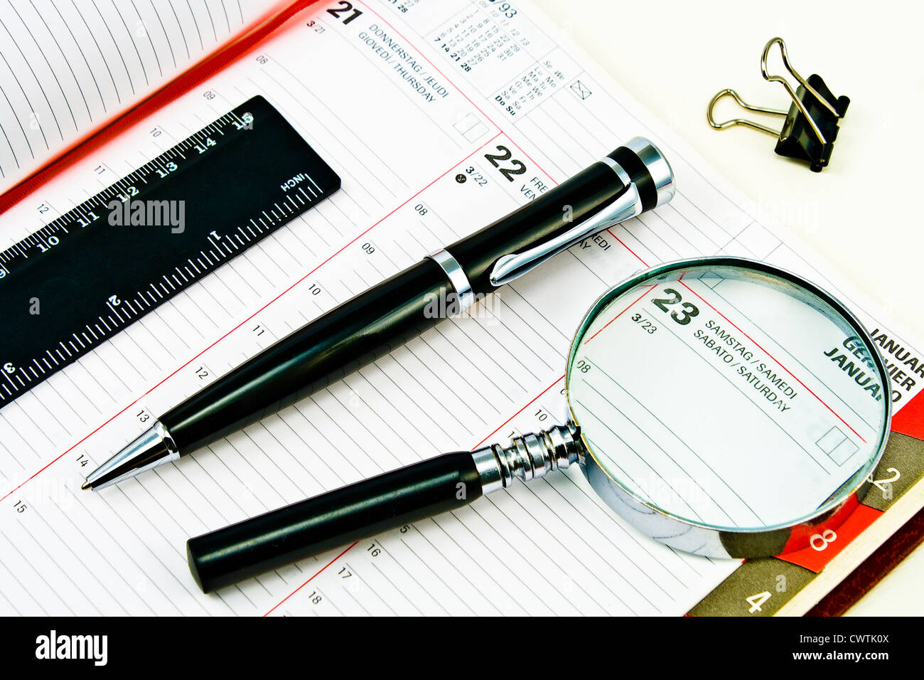 Pen and Agenda with a various tools of punctuality Stock Photo