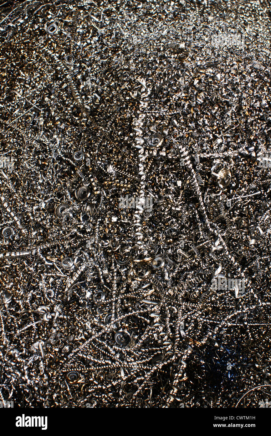 Metal shavings or swarf from an industrial manufacturing process collected in a storage bin for recycling Stock Photo