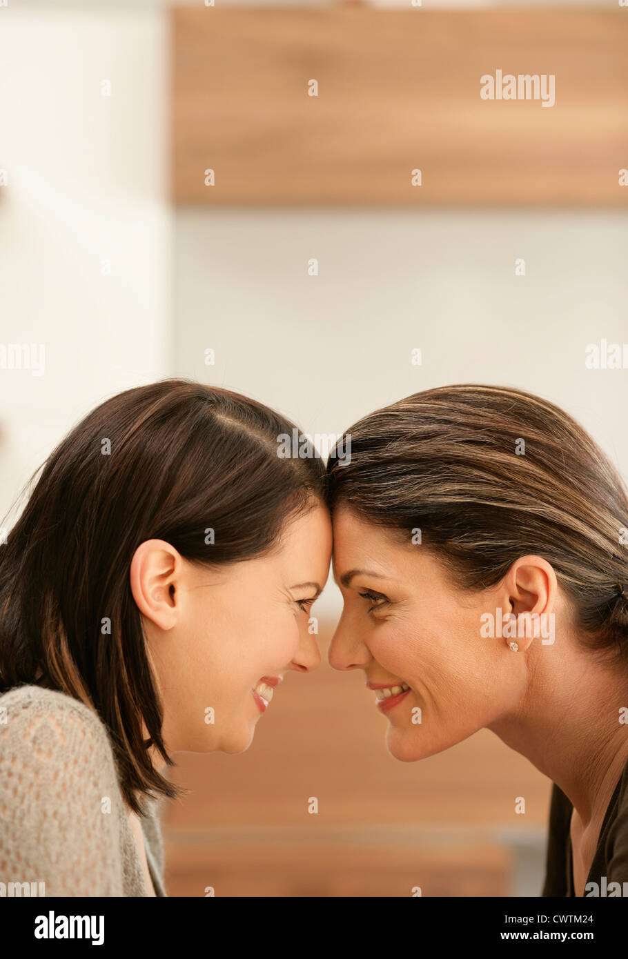 Smiling mother and adult daughter head to head Stock Photo