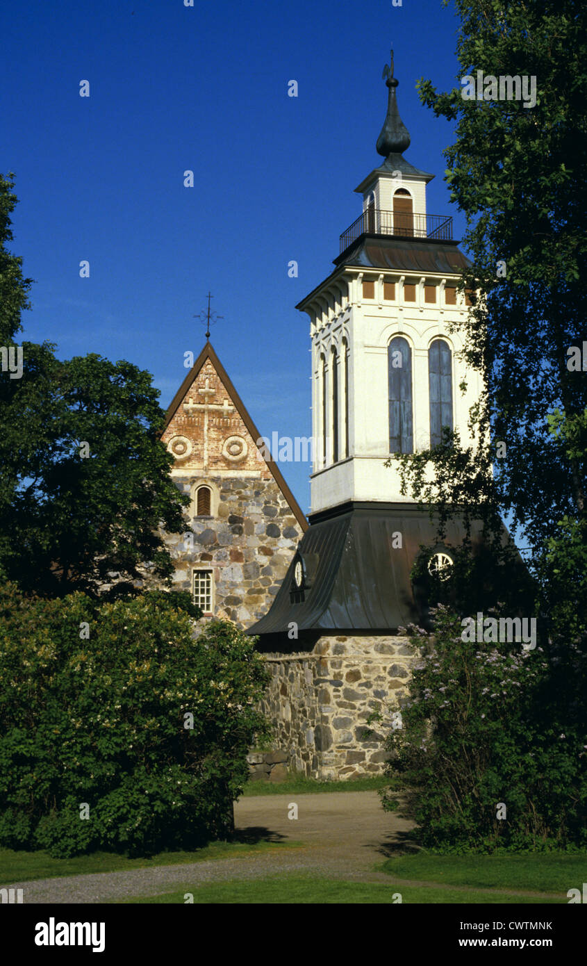 Belfry and the medieval stone Saaksmaki Church, which was built at the end of the 15th century in Valkeakoski, Finland Stock Photo