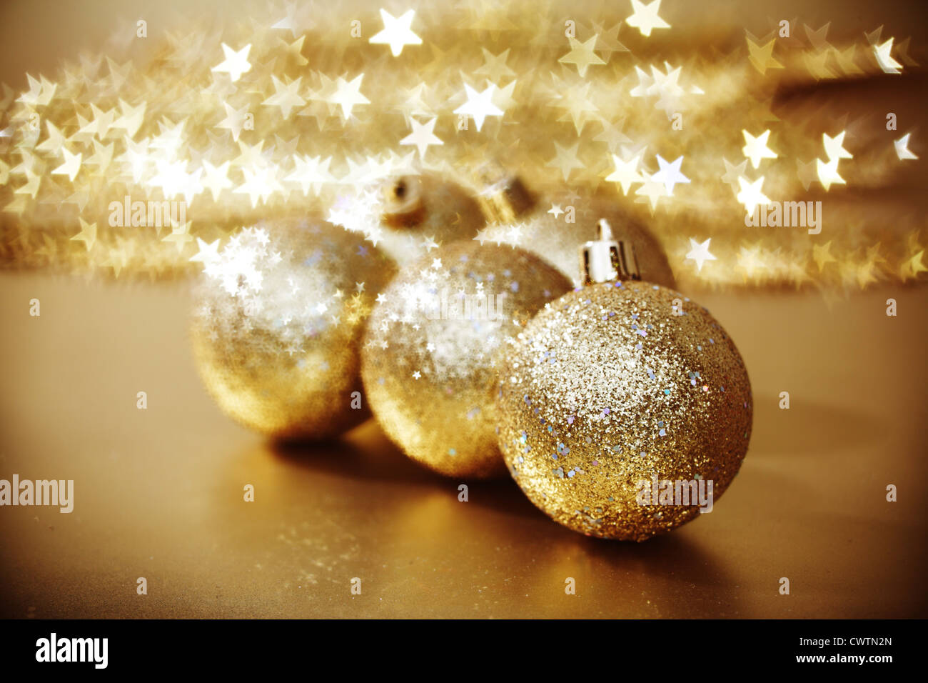 golden christmas ball on golden star bokeh background Stock Photo - Alamy