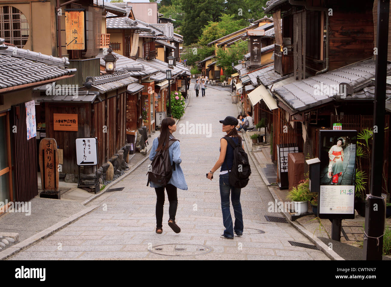 Tourists walk down Ninenzaka street, one of Kyoto