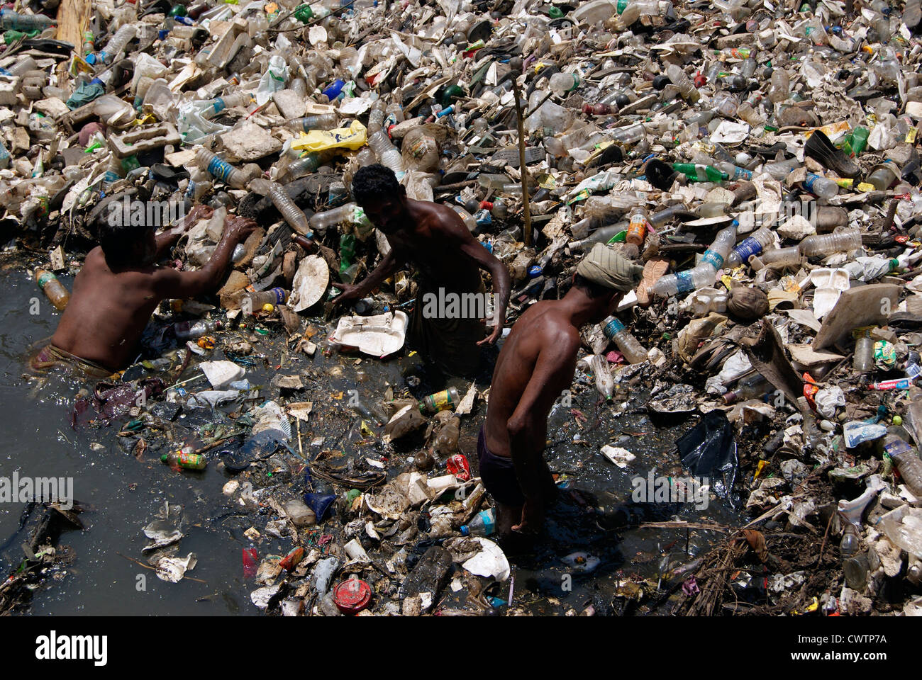Plastic and Sewage Waste Disposal Working Men from Parvathy Puthanar River flowing through Trivandrum city of Kerala in India Stock Photo