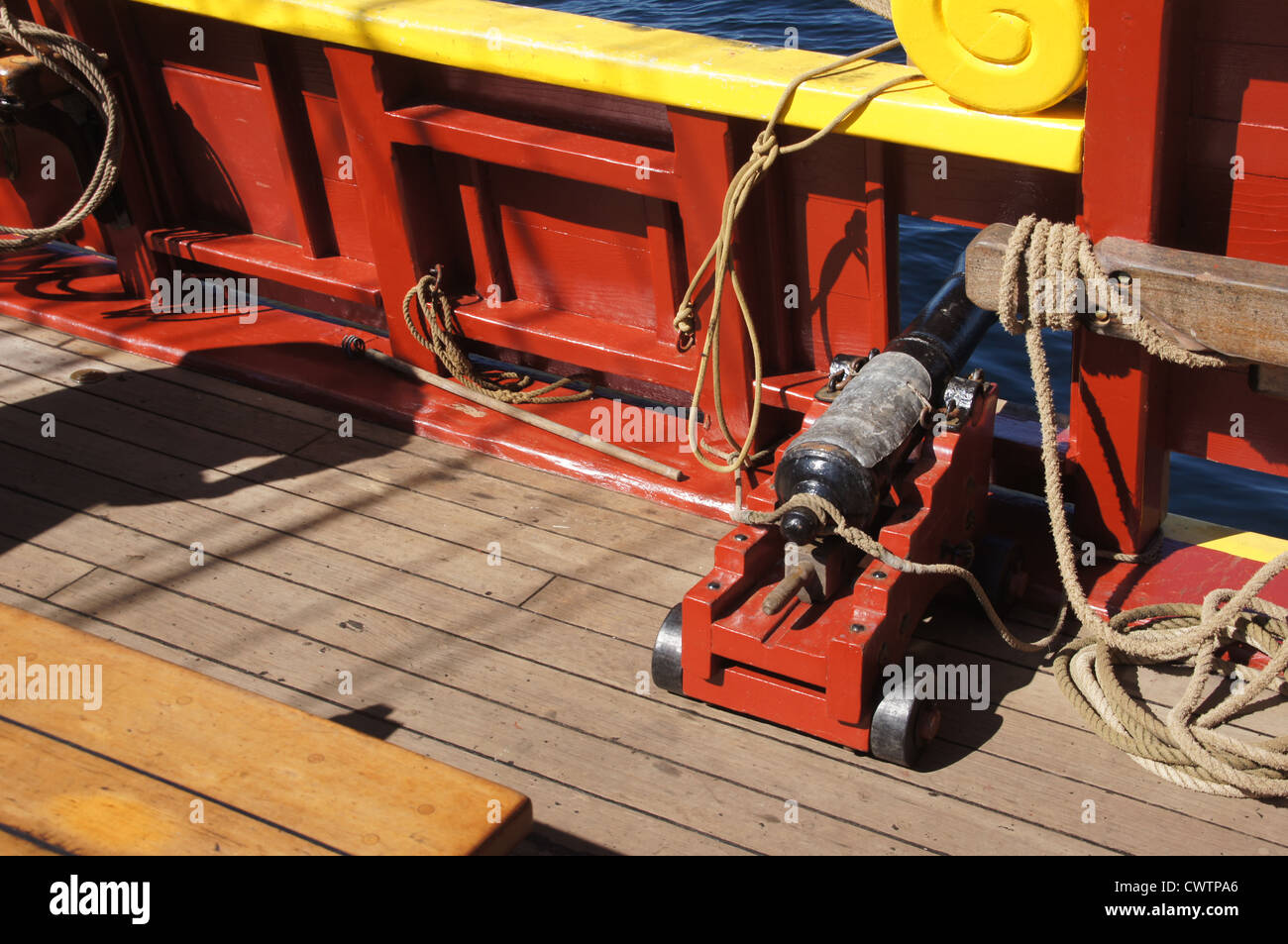 Small naval cannon on board historical wooden brig  Stock Photo