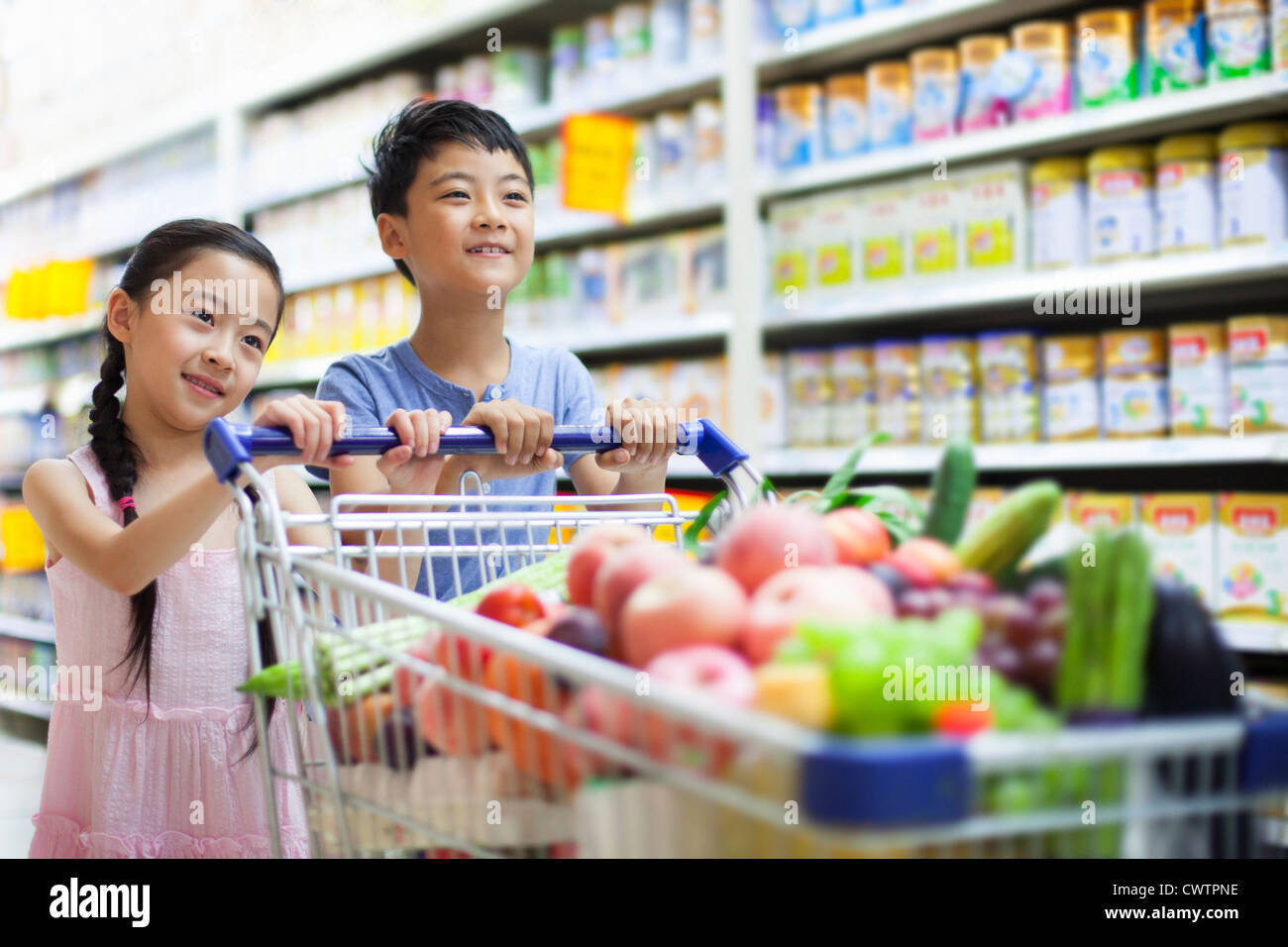 Children shopping in supermarket Stock Photo