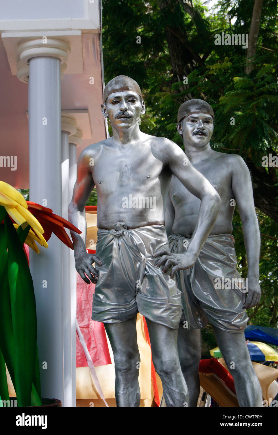 Silver man Standing Still Theme Presented on Onam celebrations in Kerala at India.Silver Painted Men Stand Still Like Statues Stock Photo