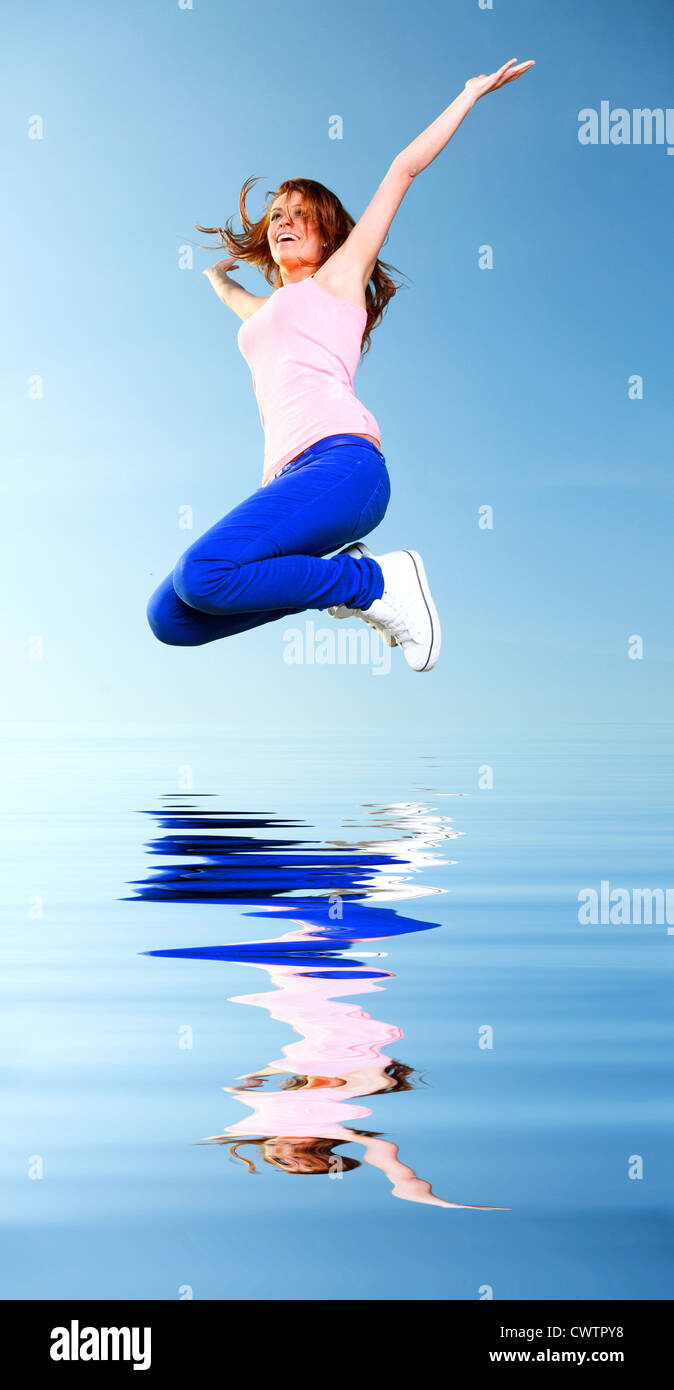 Attractive girl Young woman jumping in the sky Stock Photo - Alamy